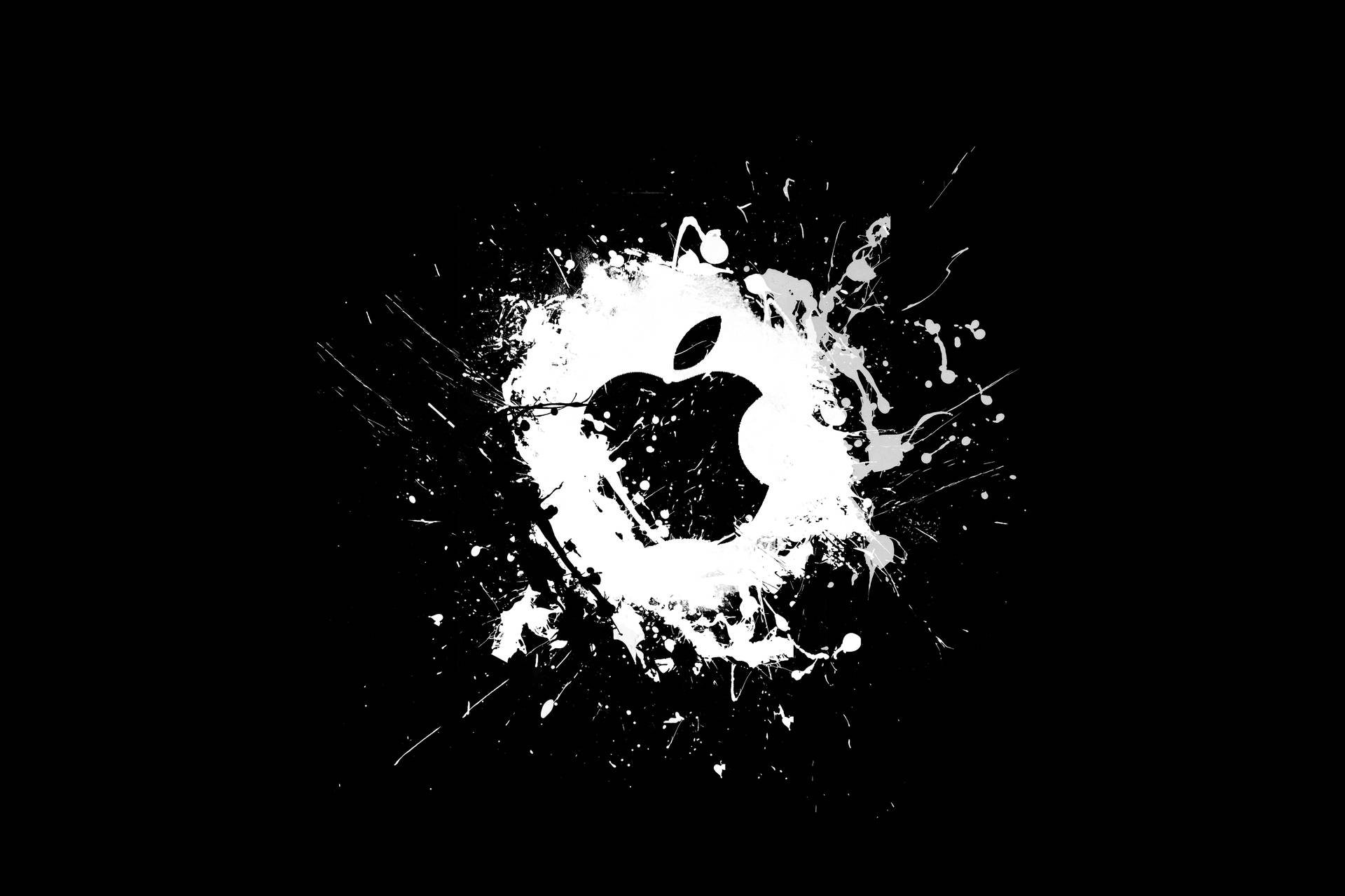 黑色背景上白色油漆飛濺形成的蘋果標誌