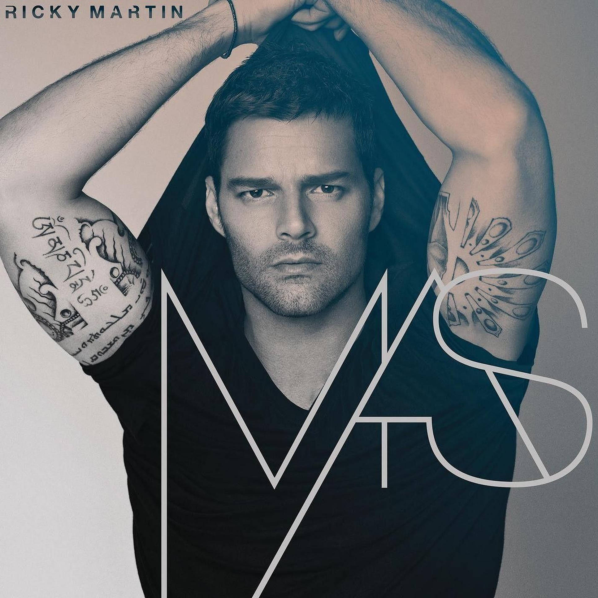 瑞奇·馬丁紋身照 壁紙 — Ricky Martin 強烈地凝視，雙臂舉起，在極簡工作室背景下展示前臂上的精細紋身。
