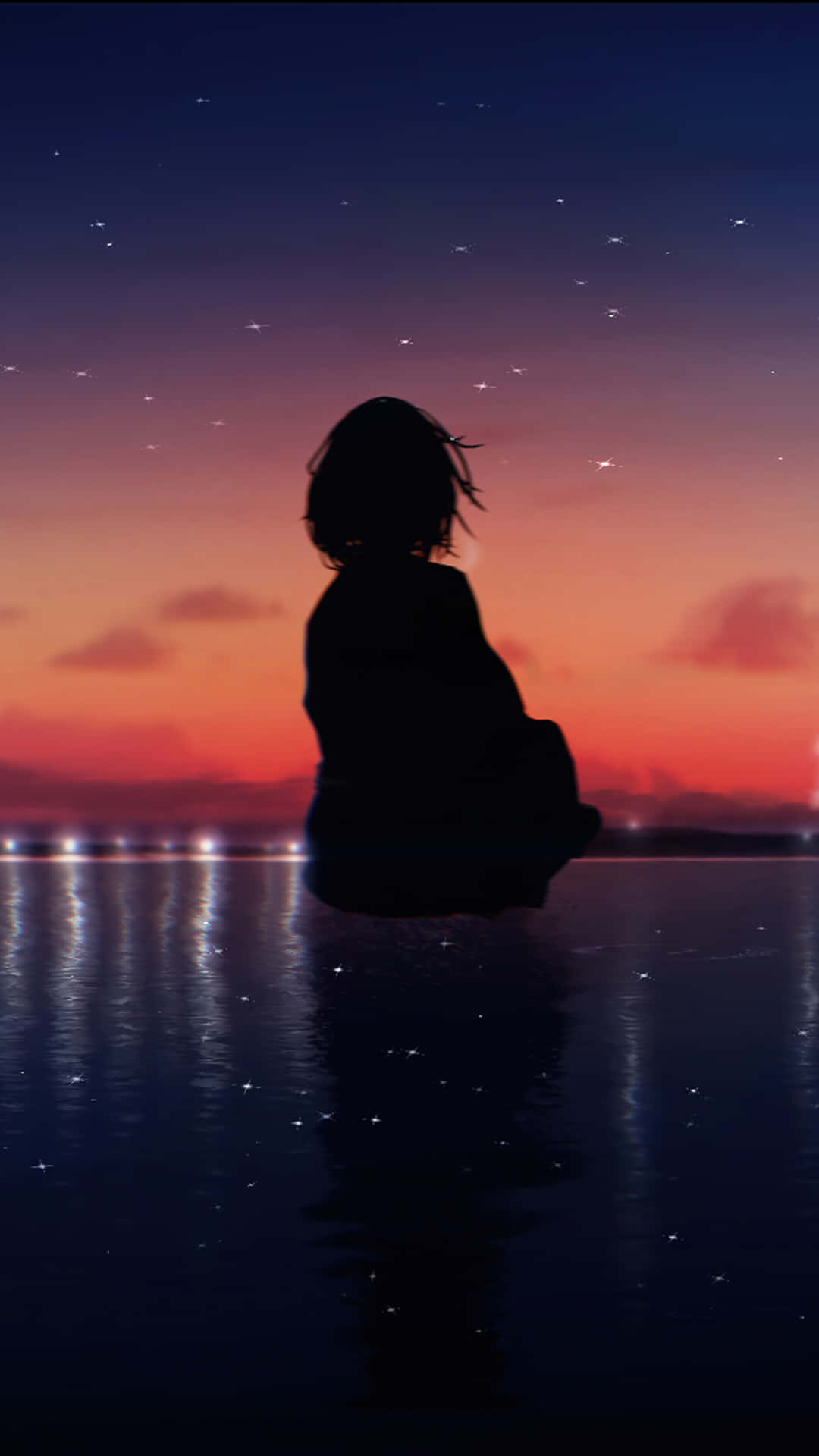 黃昏時分，星空下坐在水邊的人的剪影。