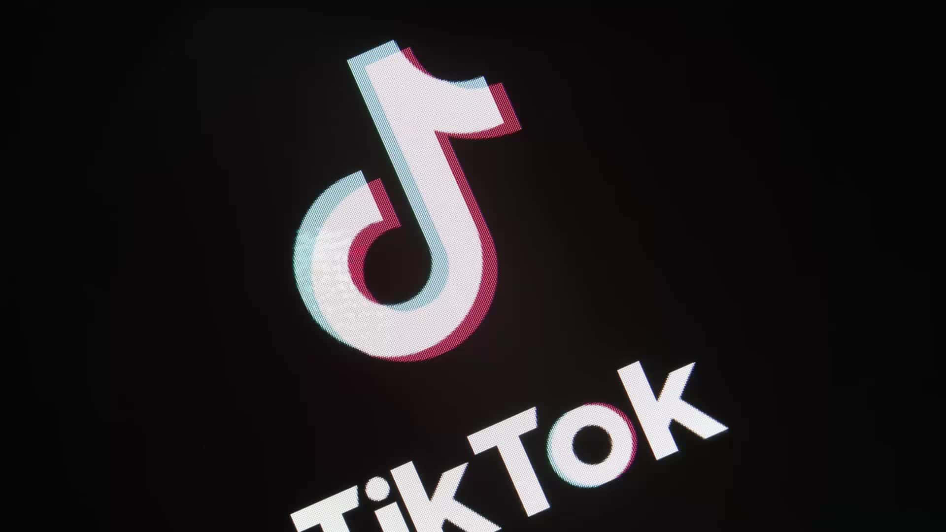 TikTok 標誌在黑色背景上發出青色和洋紅色的光芒