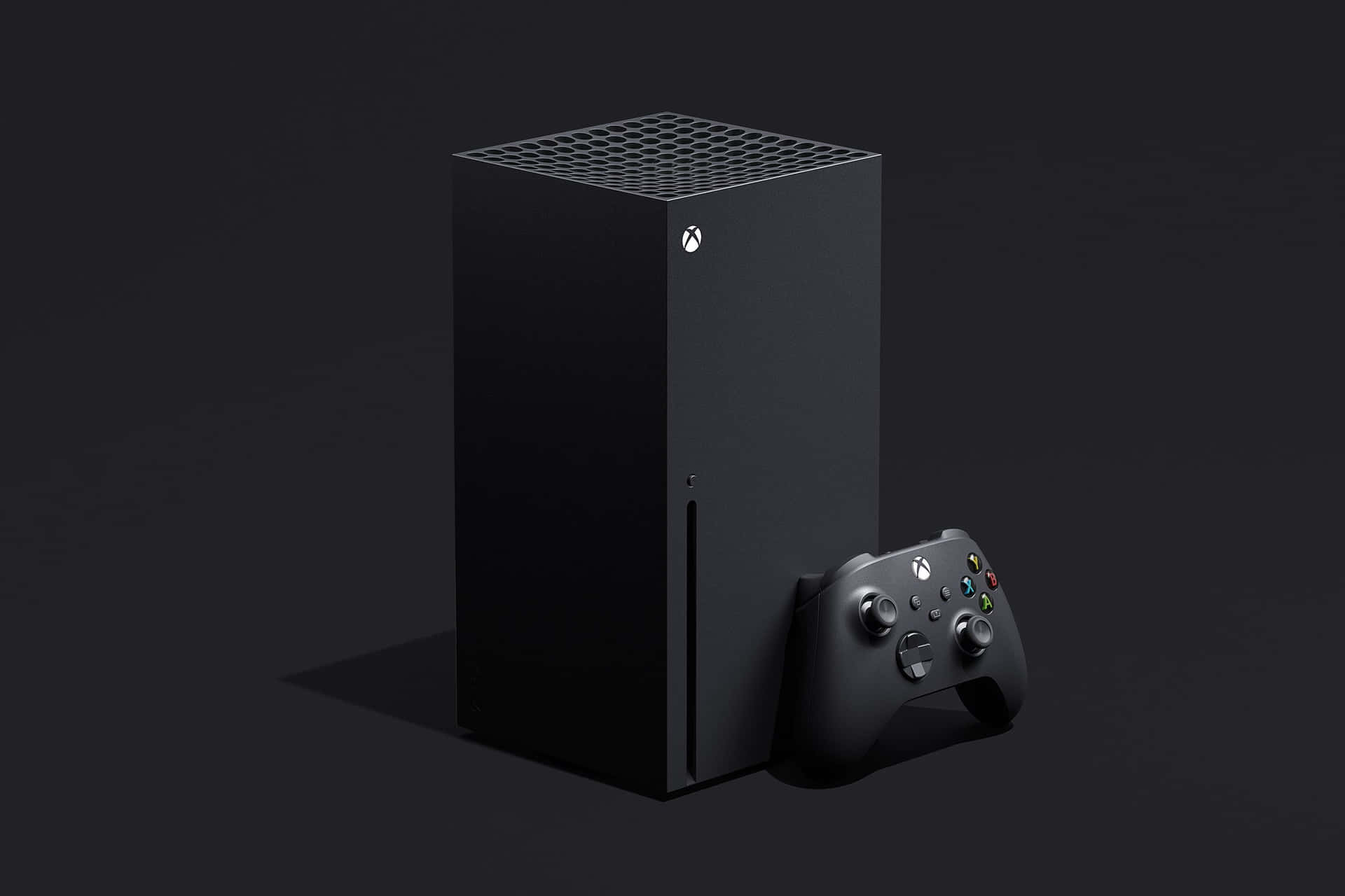 黑色 Xbox Series X 主機和控制器在深色背景上