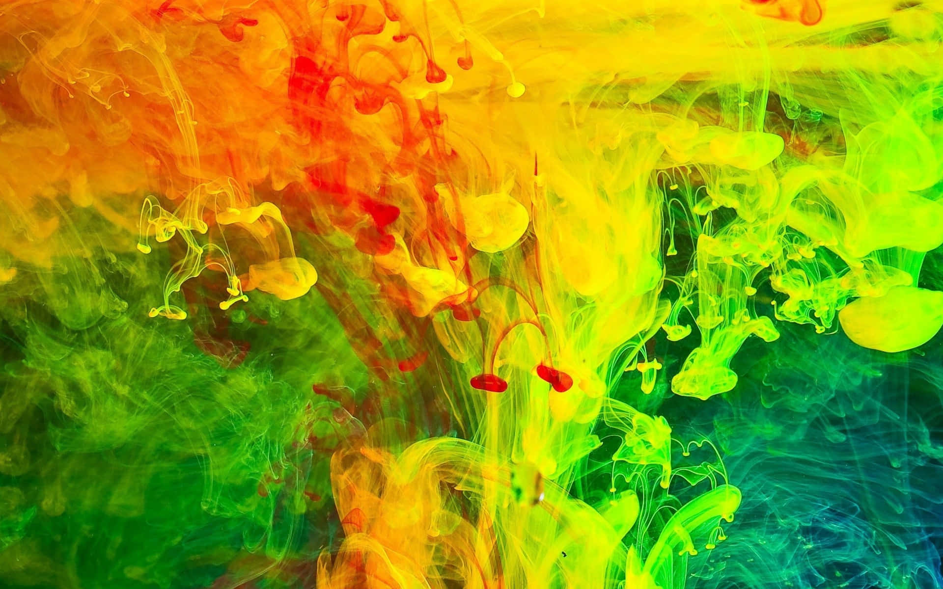 霓虹墨水在水中旋轉，創造出充滿活力的抽象圖案。