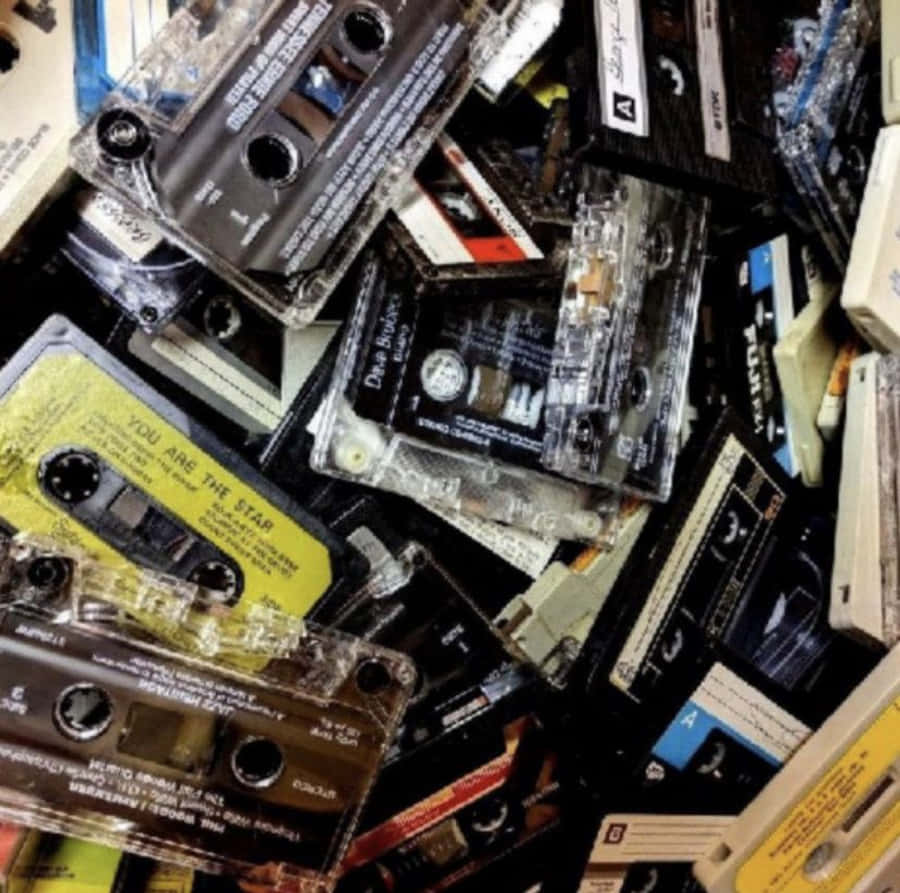 用最愛的 Mixtape 好好派對 壁紙 — 一堆混亂的復古音頻卡式錄音帶，顏色和標籤各異。