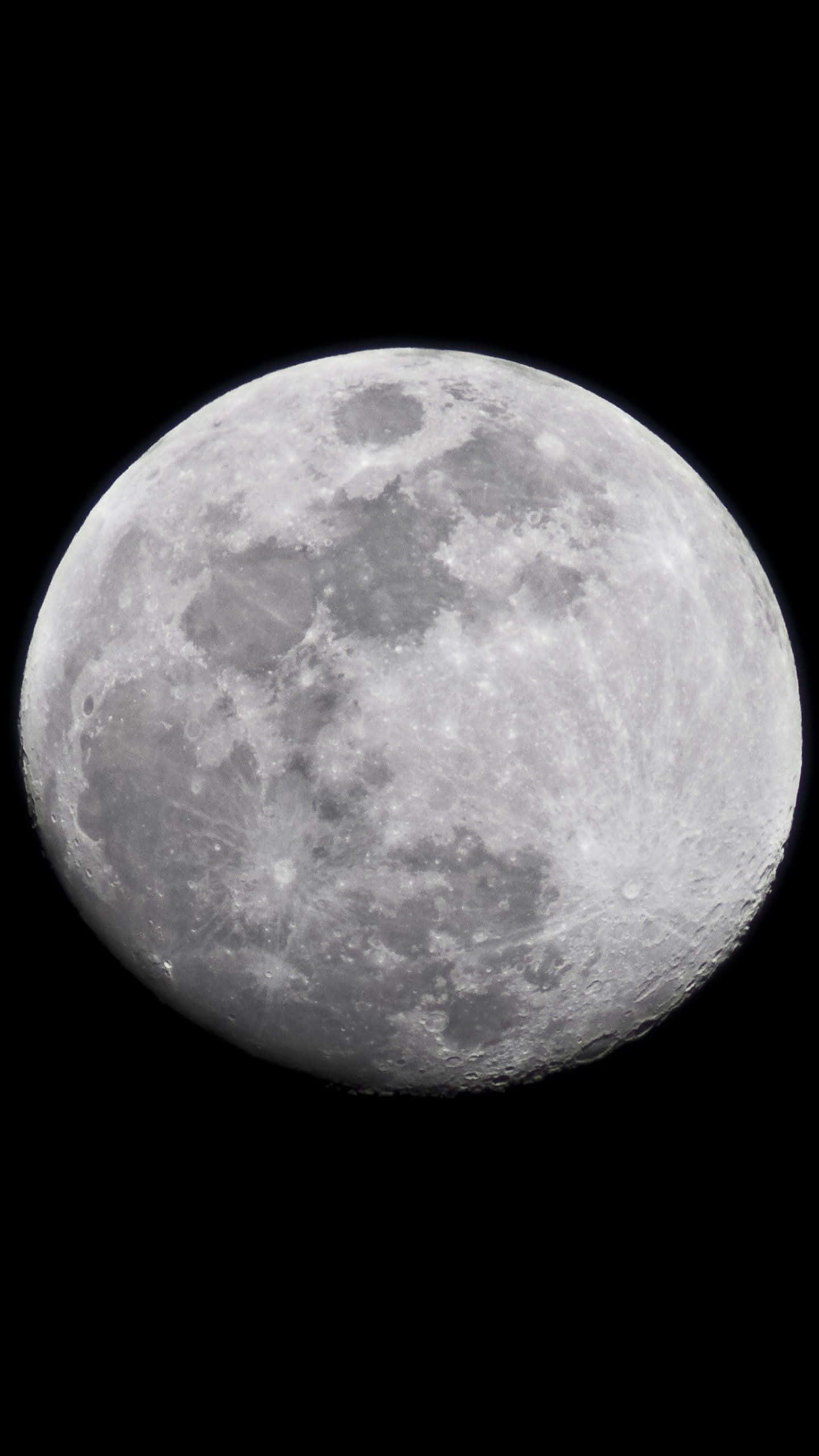 用月球iPhone探索夜空之美 壁紙 — 月球隕石坑表面的詳細特寫，在漆黑天空中柔和發光。