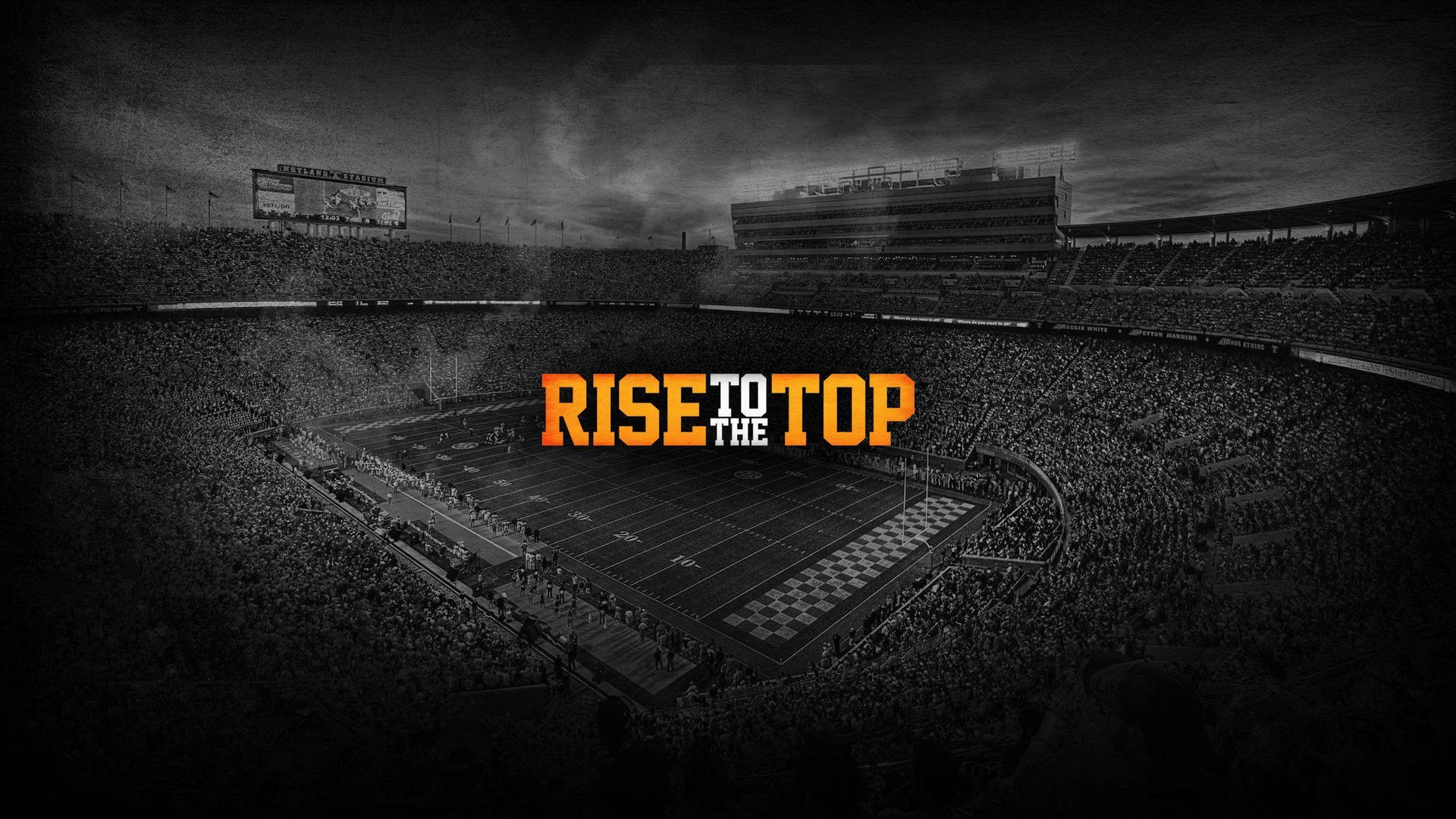 足球場擠滿球迷，在暴風雨的天空下，有勵志文字 rise to the top。
