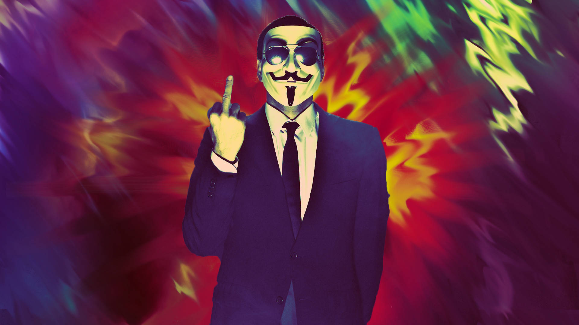 病態黑幫中指 壁紙 — 一個戴著蓋伊·福克斯面具和西裝的人，在紅、綠、紫三色火焰的迷幻爆炸中挑釁地豎起中指。