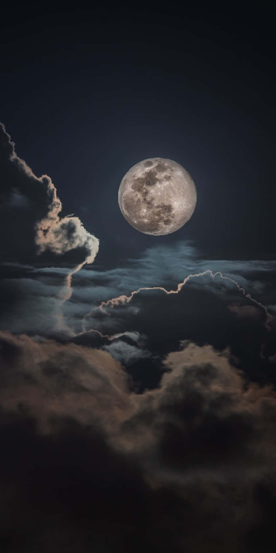 滿月穿過夜間黑暗的暴風雲閃耀。