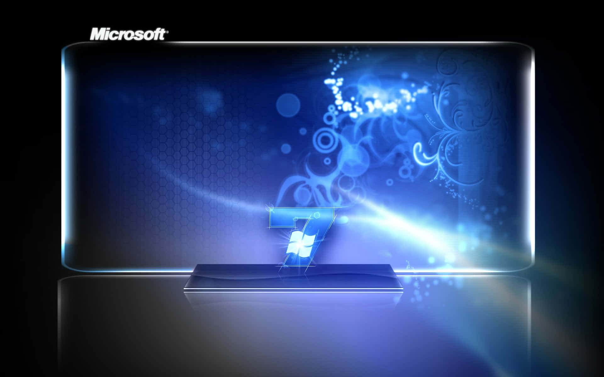Windows 7 Home 壁紙 — 發光的藍色Windows 7標誌從一個顯示抽象數字漩渦和光效的時尚顯示器中浮現。