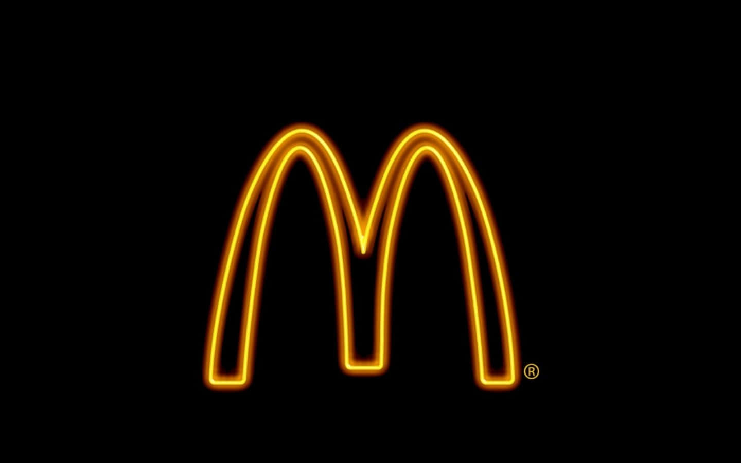 Logo 桌布 壁紙 — 發光的金色麥當勞拱門標誌在純黑色背景上明亮閃耀。