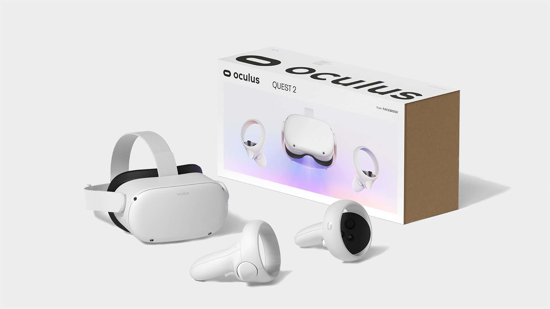 Oculus Quest 2 桌布 壁紙 — 白色Oculus Quest 2 VR頭戴式裝置和控制器，旁邊是其品牌盒子，背景為簡約工作室風格。