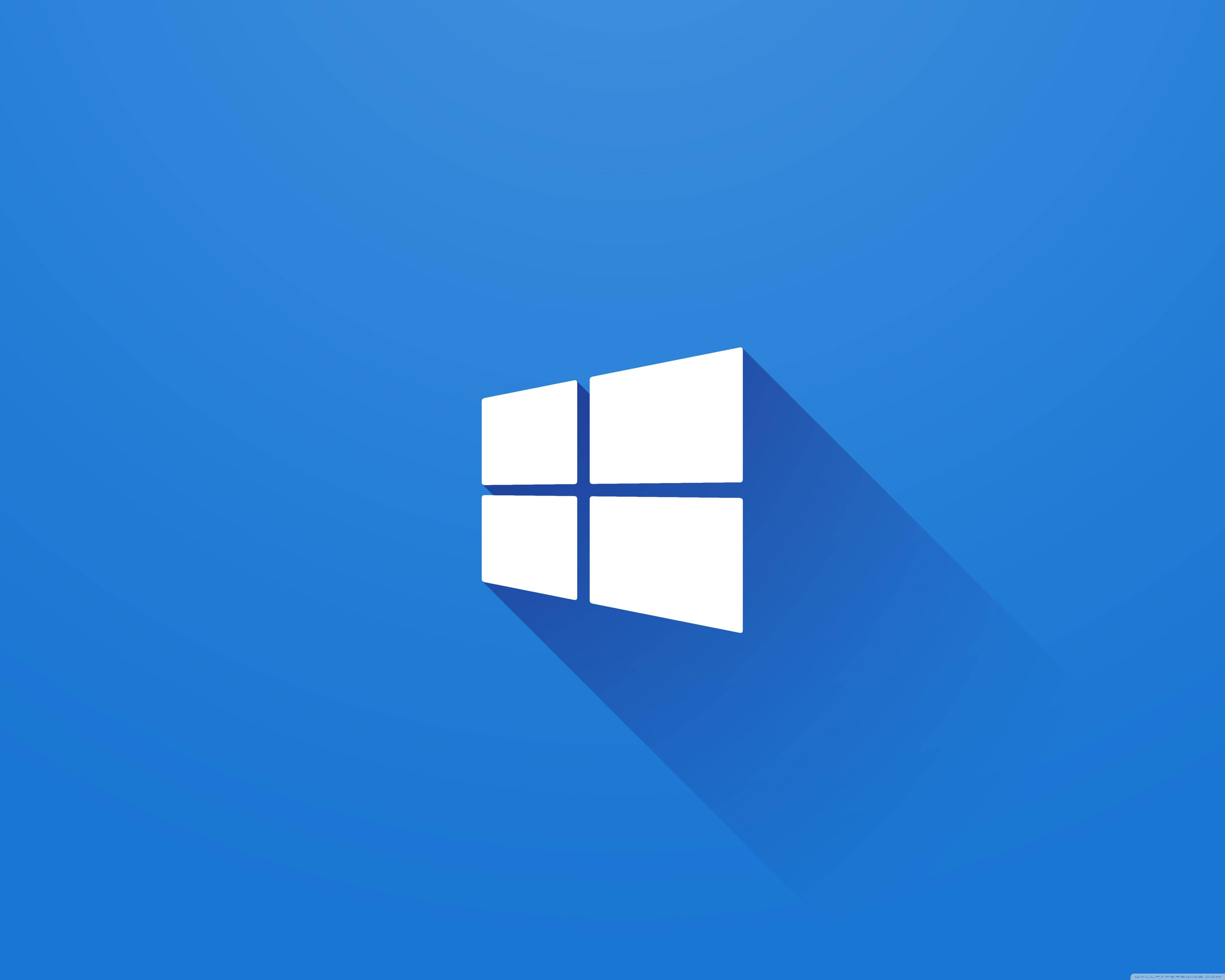 白色Windows標誌 壁紙 — 白色Windows標誌在漸變藍色背景上投下長長的陰影。