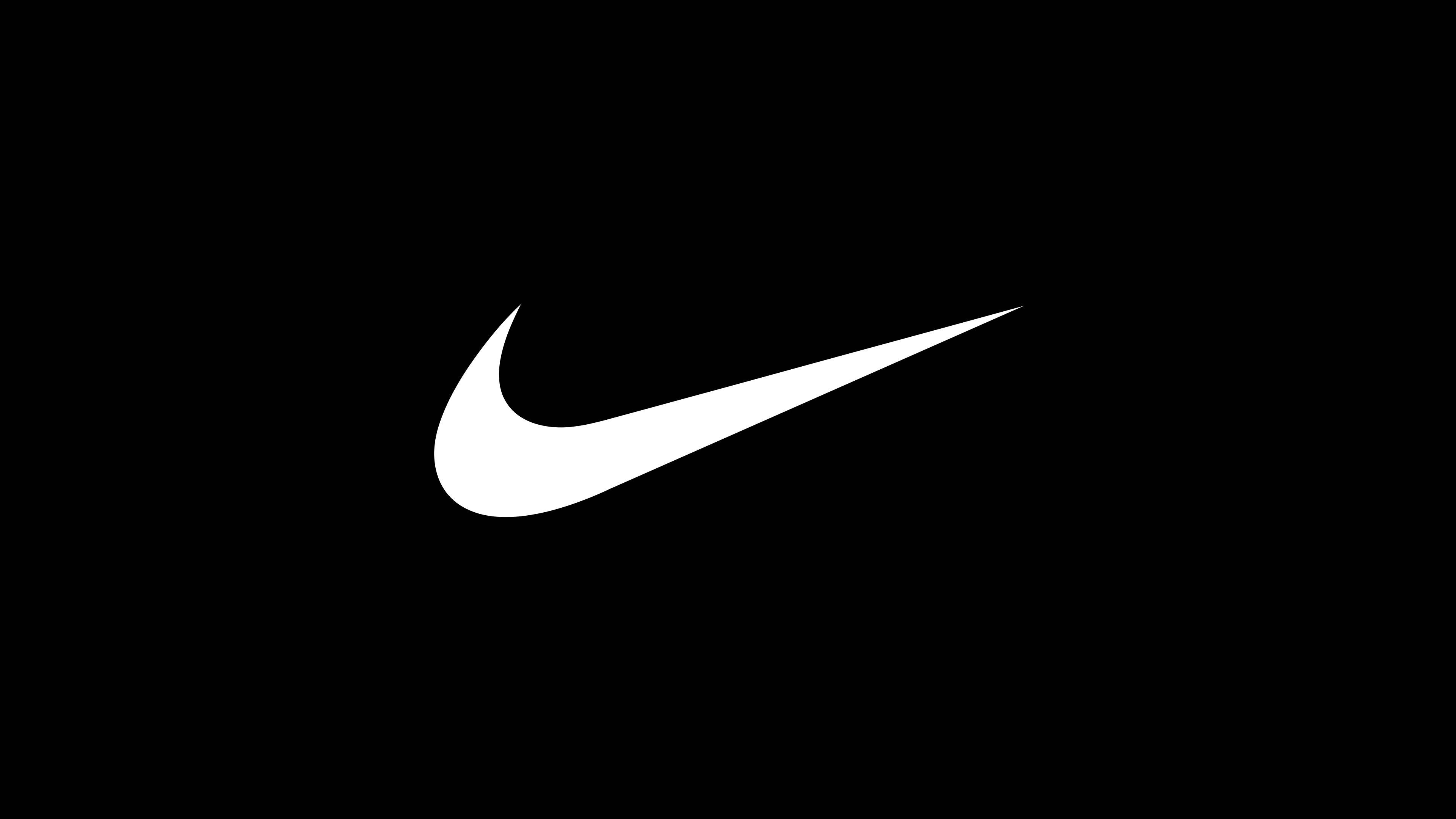 白色耐克勾形標誌 壁紙 — 一個鮮明的白色Nike Swoosh標誌置於純黑色背景中央。
