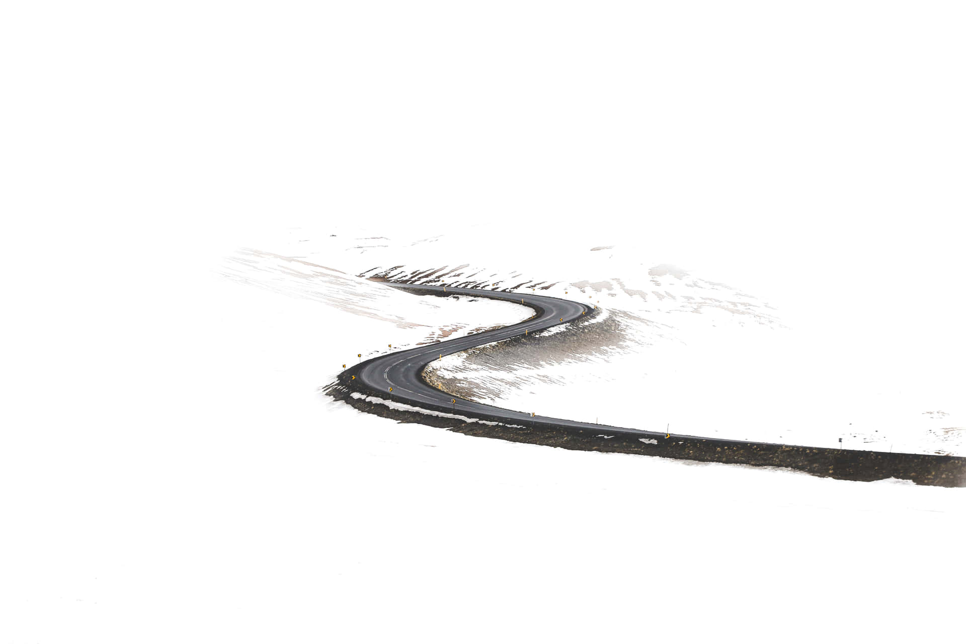 冬季穿過雪山蜿蜒的道路