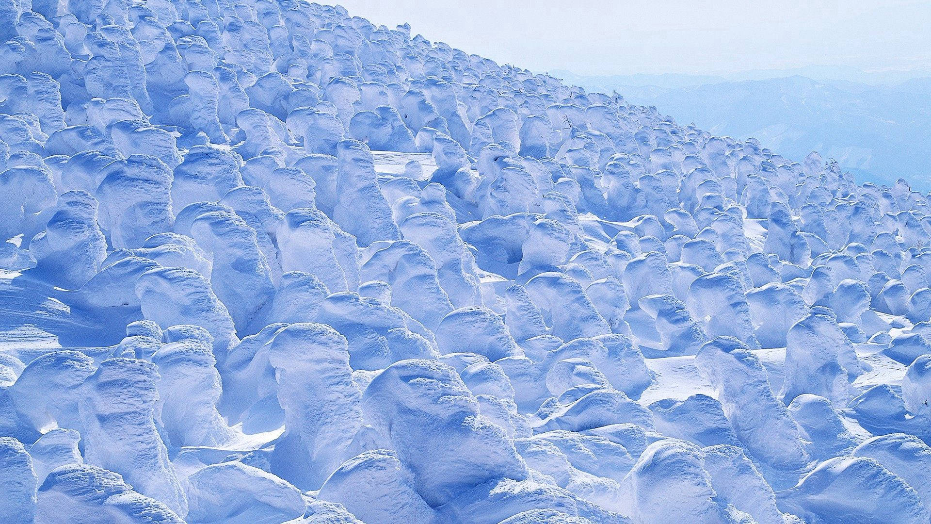 風吹成的雪堆覆蓋了冬天的山坡。