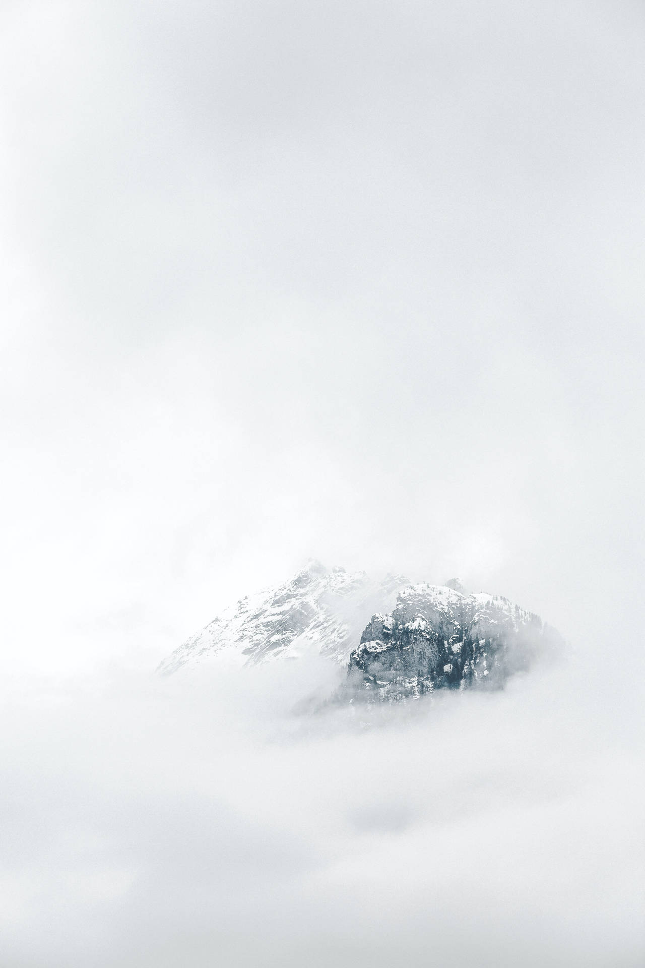 冬日裡，白雪覆蓋的山峰聳立於雲海之上。
