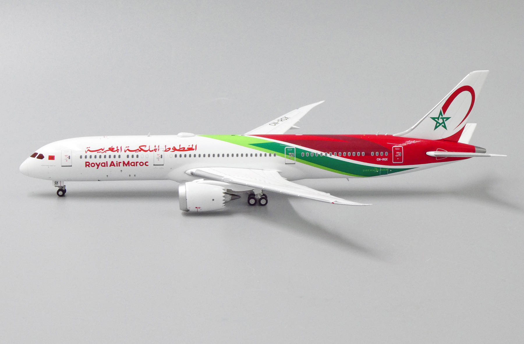 皇家摩洛哥航空飛機玩具模型 壁紙 — 皇家摩洛哥航空波音787夢幻客機的詳細模型，紅綠白塗裝，純灰色背景。