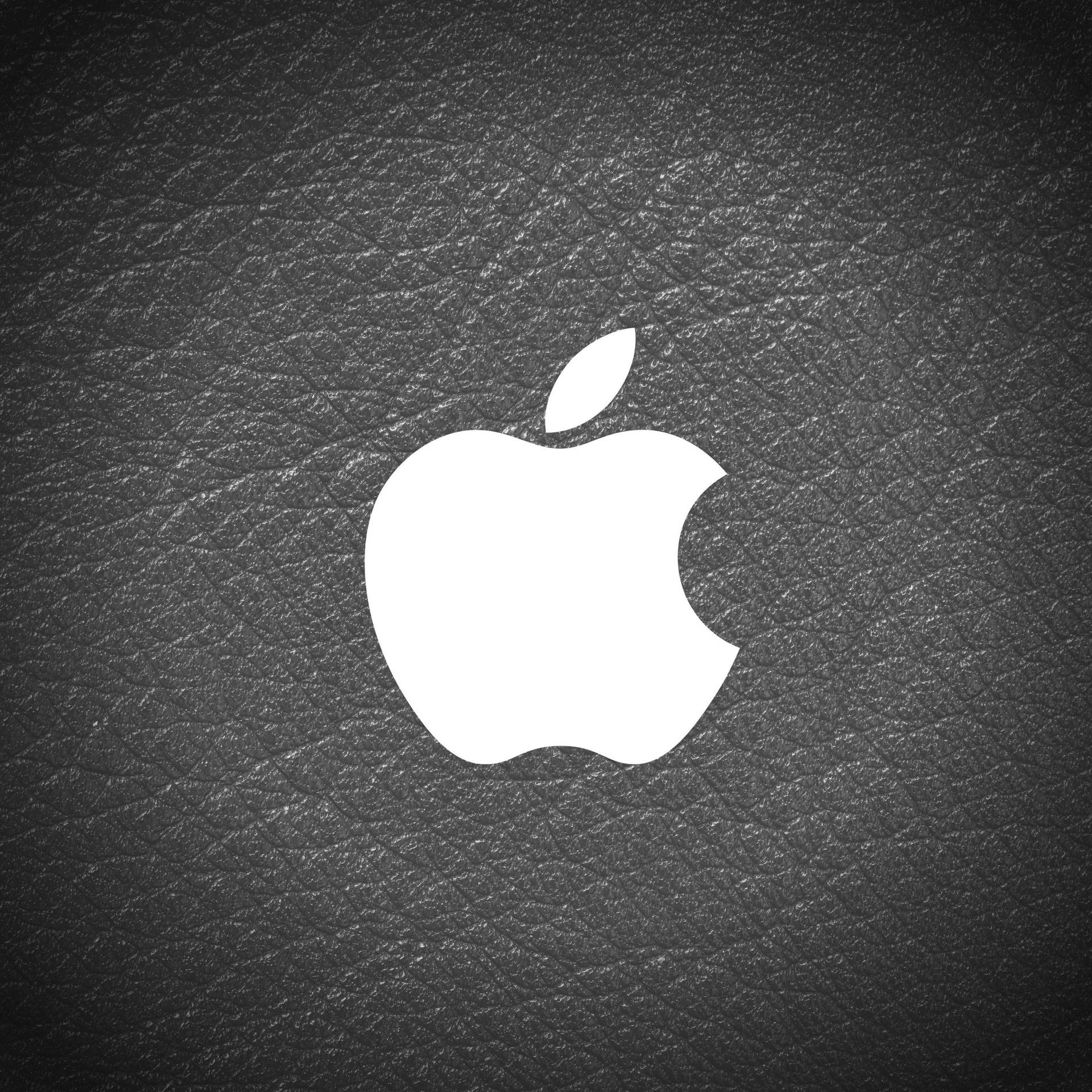 黑色皮革背景上的白色Apple標誌