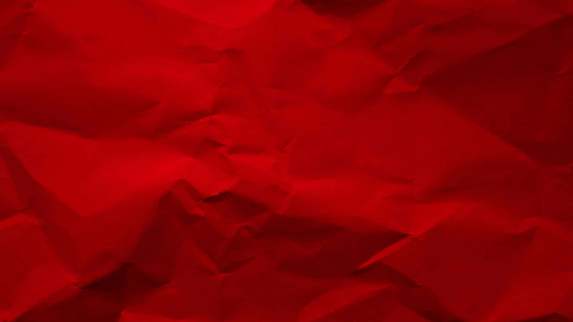 帶有紋理褶皺和柔和光線的豐富紅色皺紙。