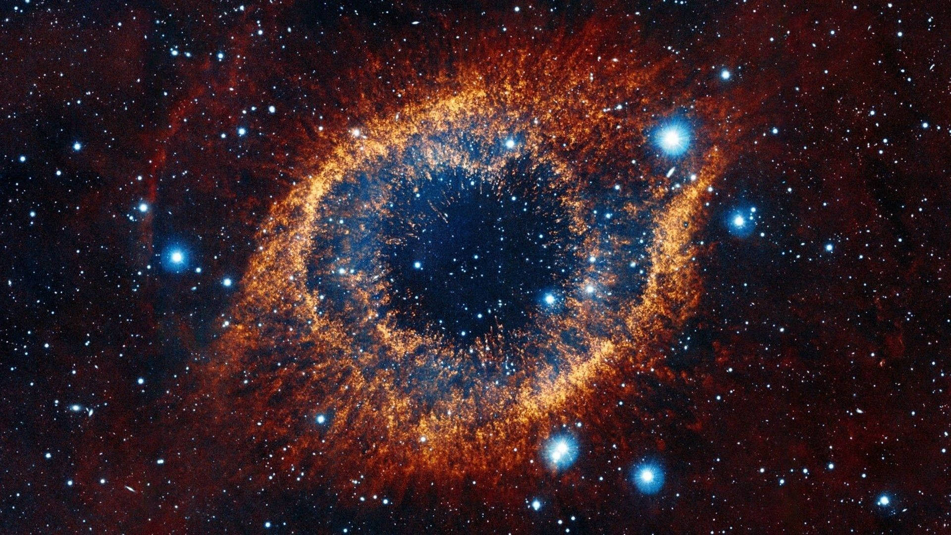 一個充滿活力的宇宙星雲，帶有發光橙色氣體和藍色恆星，環繞著黑暗中心。