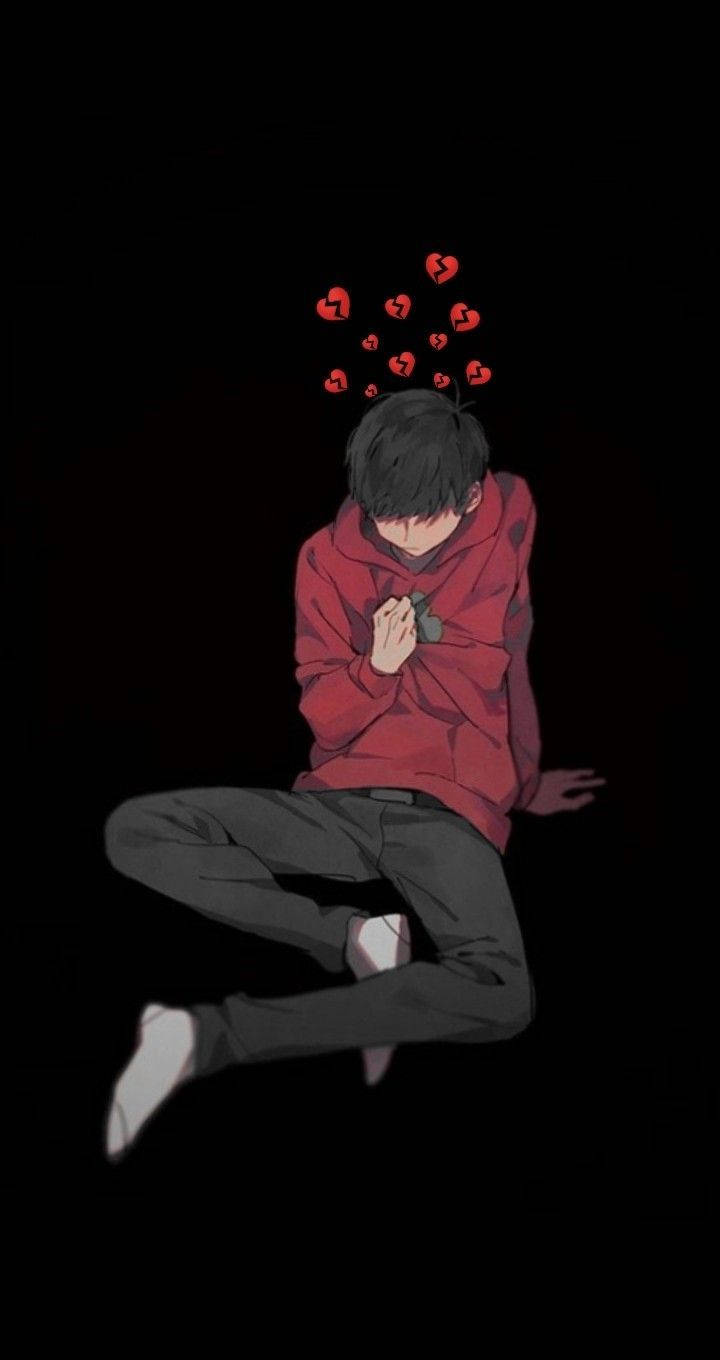 破碎心碎動漫男孩傷感美學 壁紙 — 一個穿著紅色連帽衫的年輕動漫男孩彎腰坐著，破碎的心漂浮在他的頭上，背景是黑色。