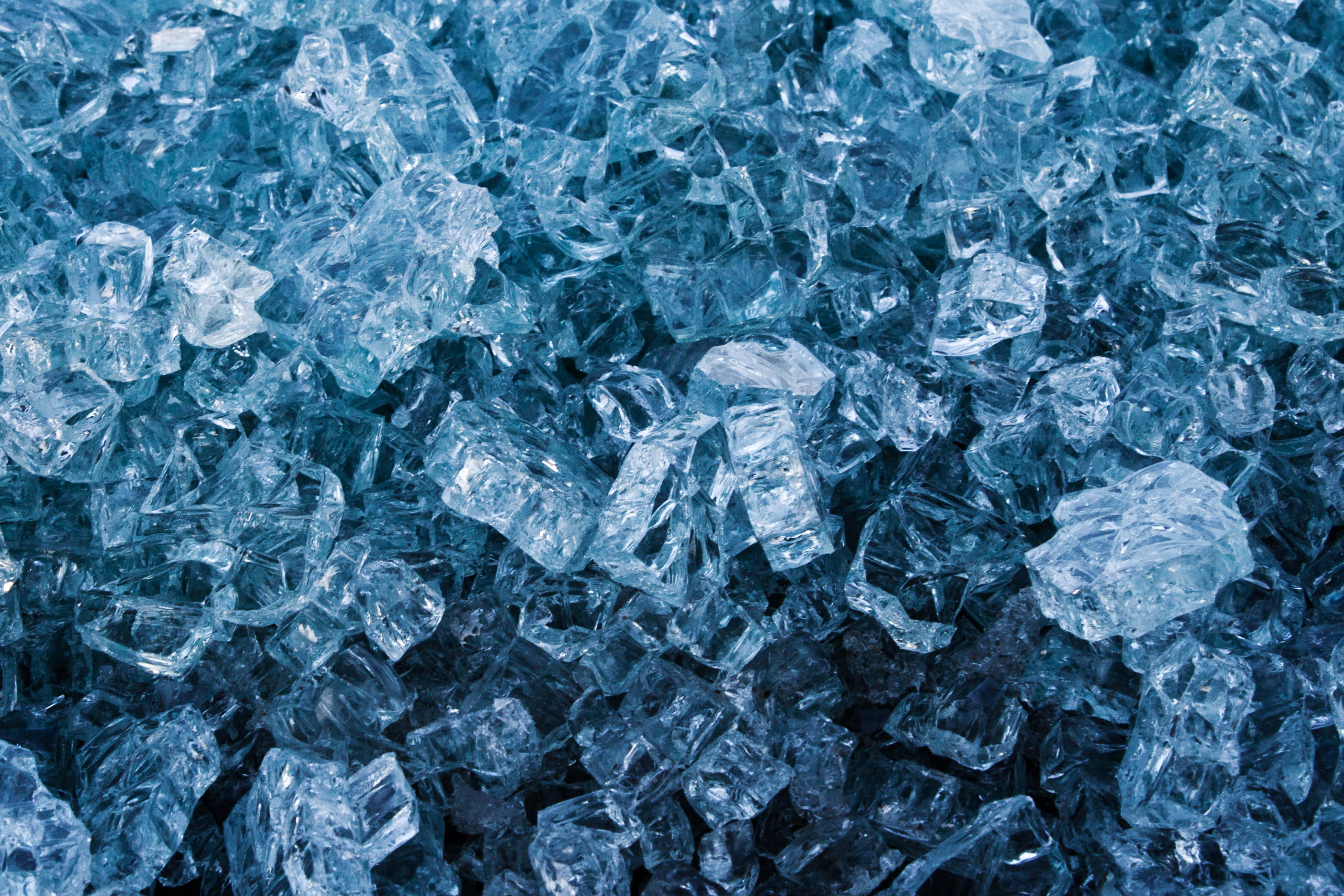 Gemstone 桌布 壁紙 — 碎裂藍色玻璃碎片的特寫，閃爍著鋒利邊緣和半透明高光。