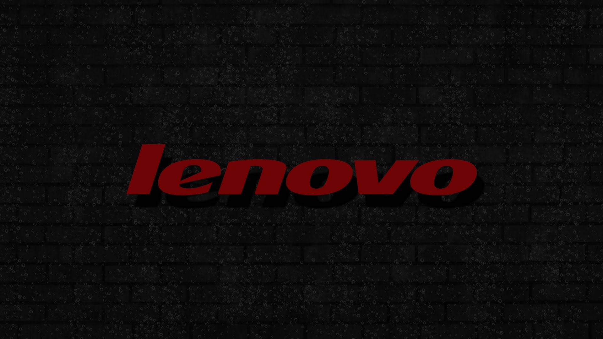 紅色Lenovo標誌在黑色磚牆上帶有陰影效果。