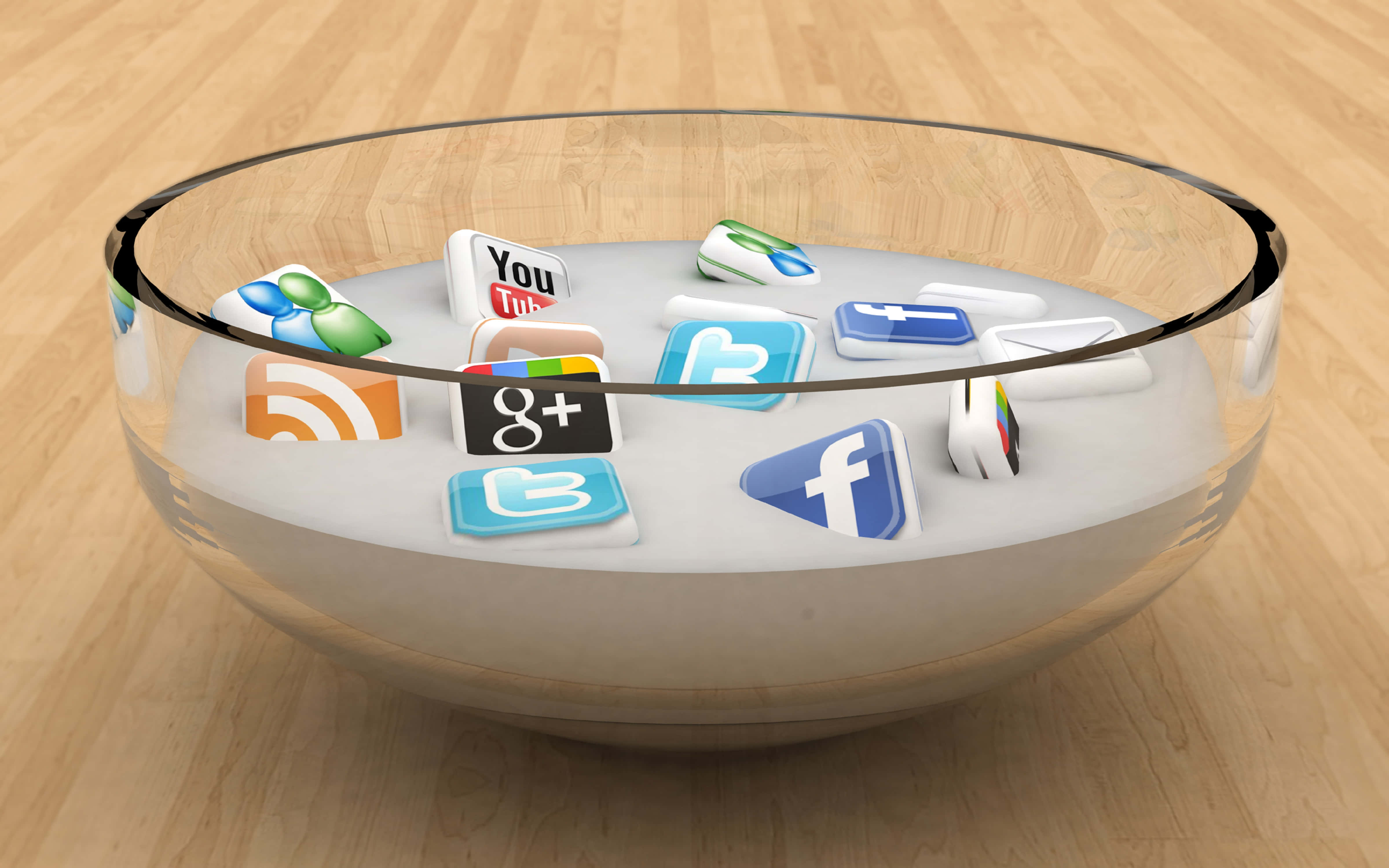 4K Social Media 桌布 壁紙 — 社交媒體應用程式圖標漂浮在一個裝有白色液體的透明玻璃碗中，置於木地板上。