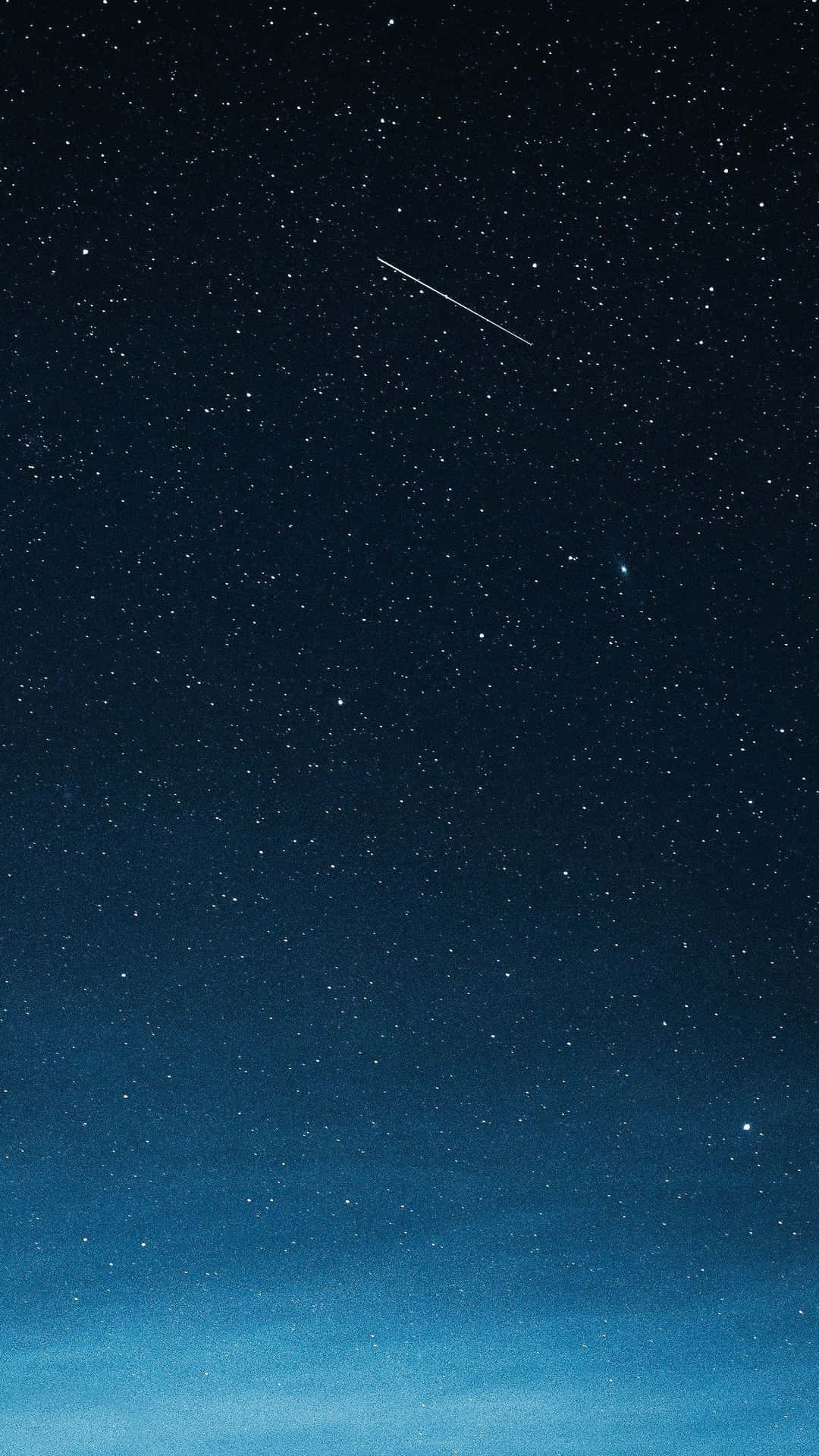 一個深藍色的夜空，有星星和一顆流星。