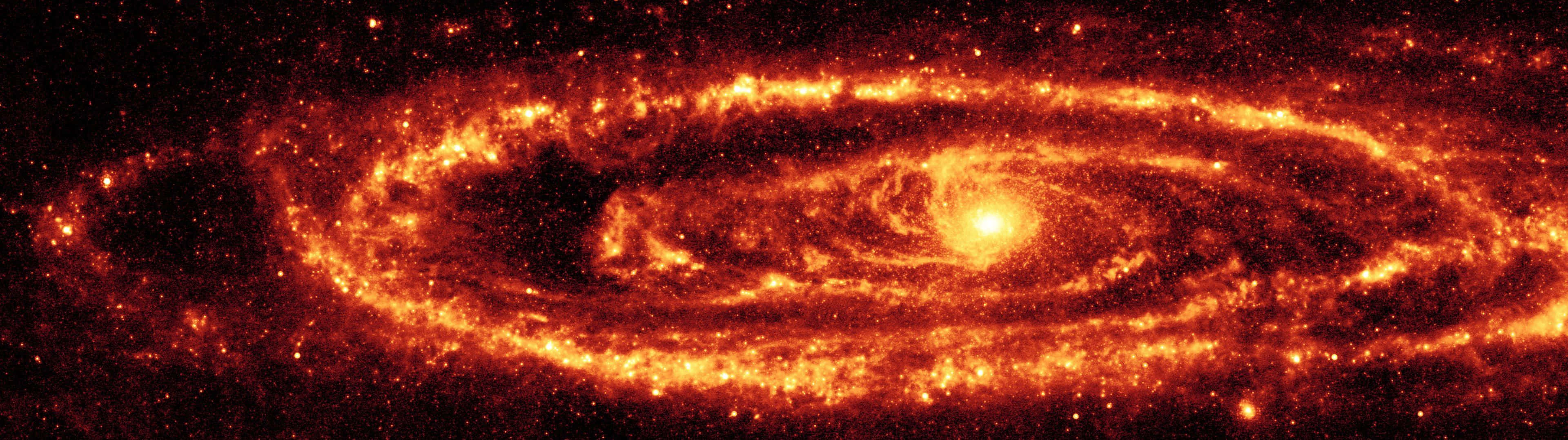 一個發光的螺旋星系，帶有熾熱的橙色旋臂和明亮的星星，背景是黑暗的宇宙。