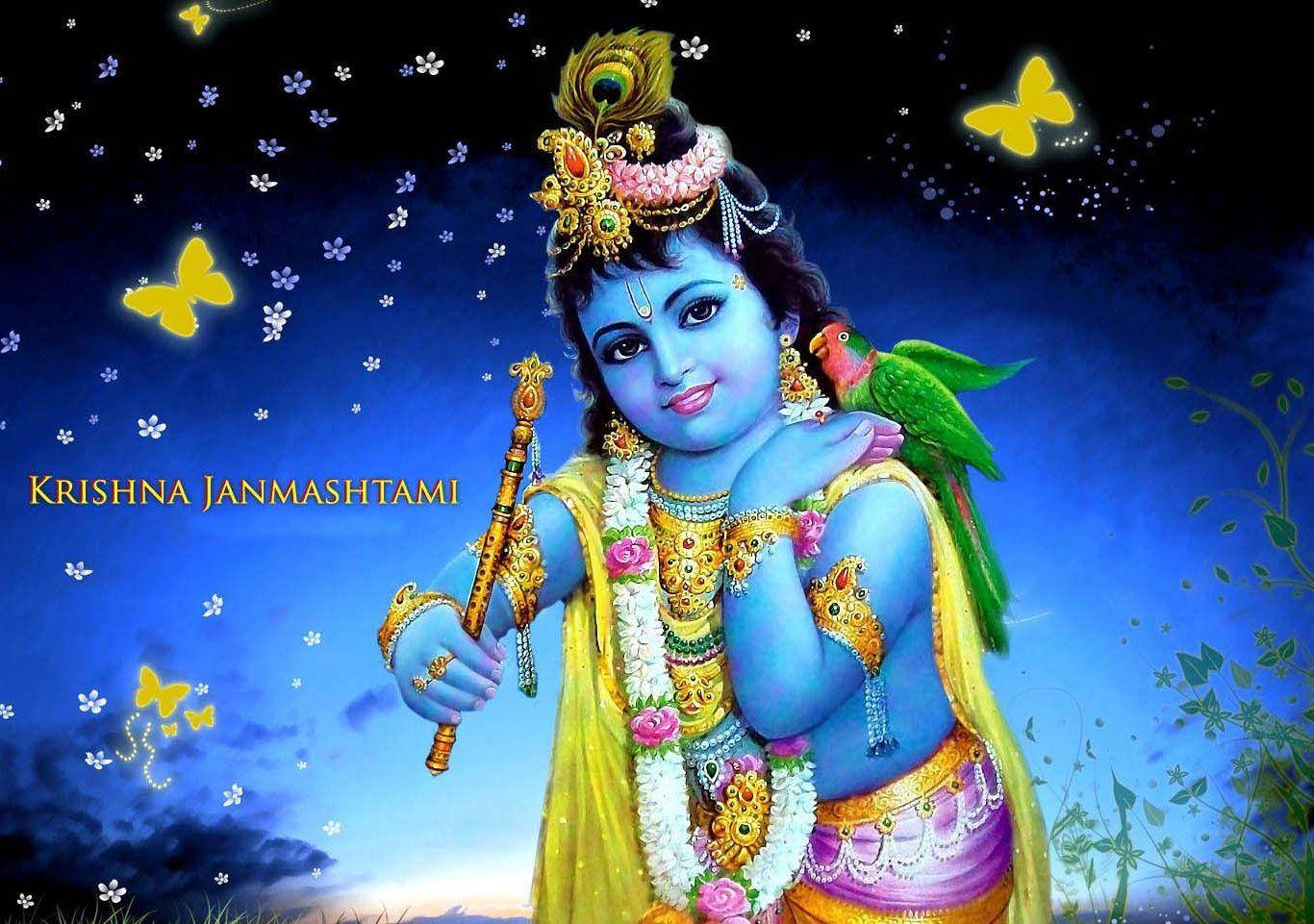 krishna god 桌布 壁紙 — 神聖的藍皮膚克里希納，飾有金色珠寶和黃色衣服，手持長笛，一隻綠色鸚鵡棲息在他的肩膀上，背景是繁星點點的夜空和發光的蝴蝶。