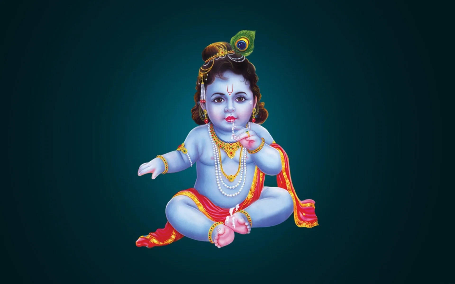 Bal Krishna 桌布 壁紙 — 神聖的藍皮膚嬰兒克里希納盤腿而坐，飾有黃金首飾和孔雀羽毛皇冠，背景為深藍綠色。