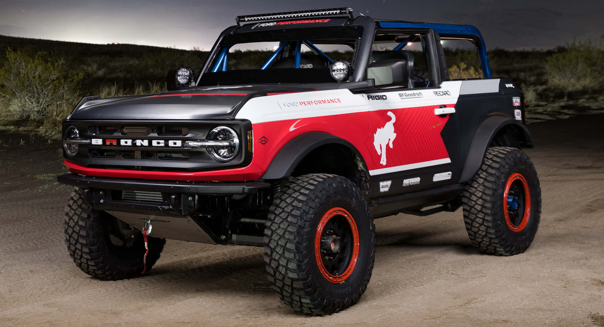 訂製福特 Bronco 越野賽車在暮色中停泊於沙漠。