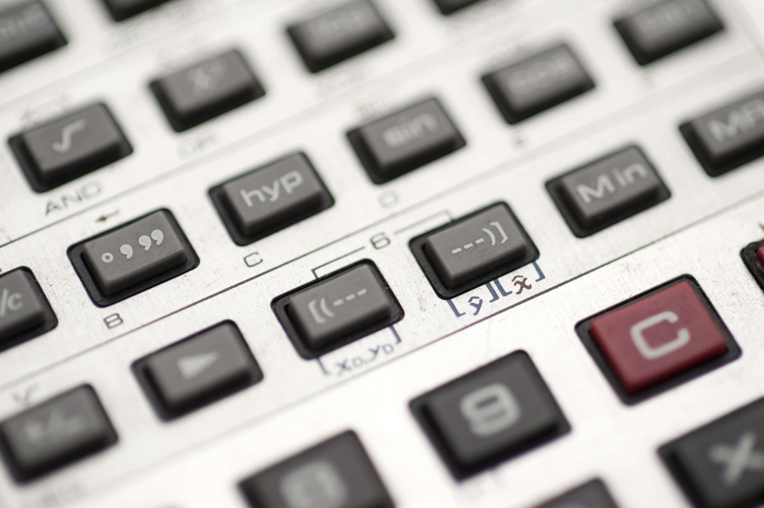Calculator 桌布 壁紙 — 科學計算機鍵盤特寫，黑色按鍵，銀色表面上有一個紅色「C」鍵。