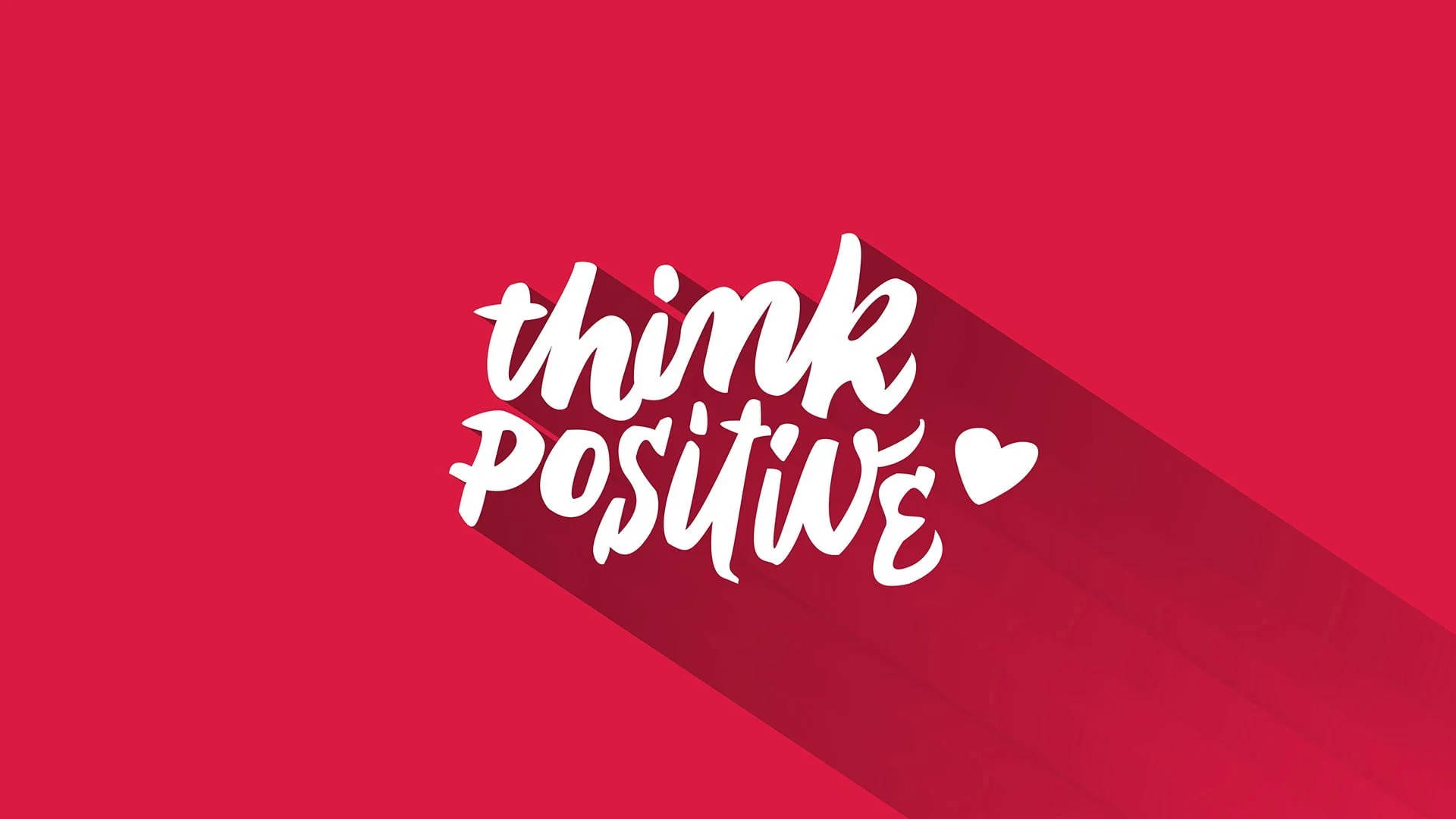 紅色背景上帶有白色「think positive」文字和心形圖標，投射出長陰影。