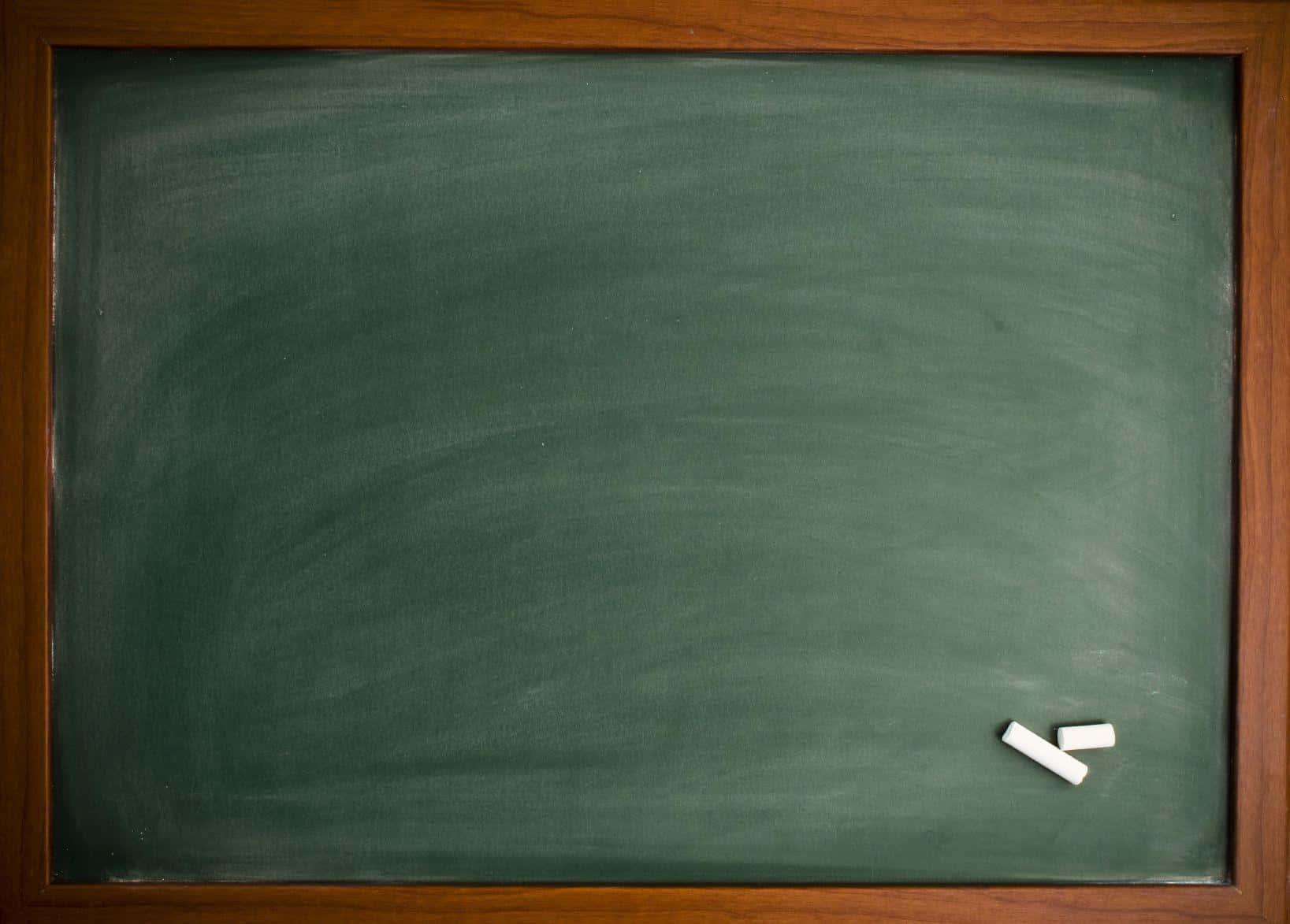 空的綠色黑板，帶有木框和兩支白色粉筆。
