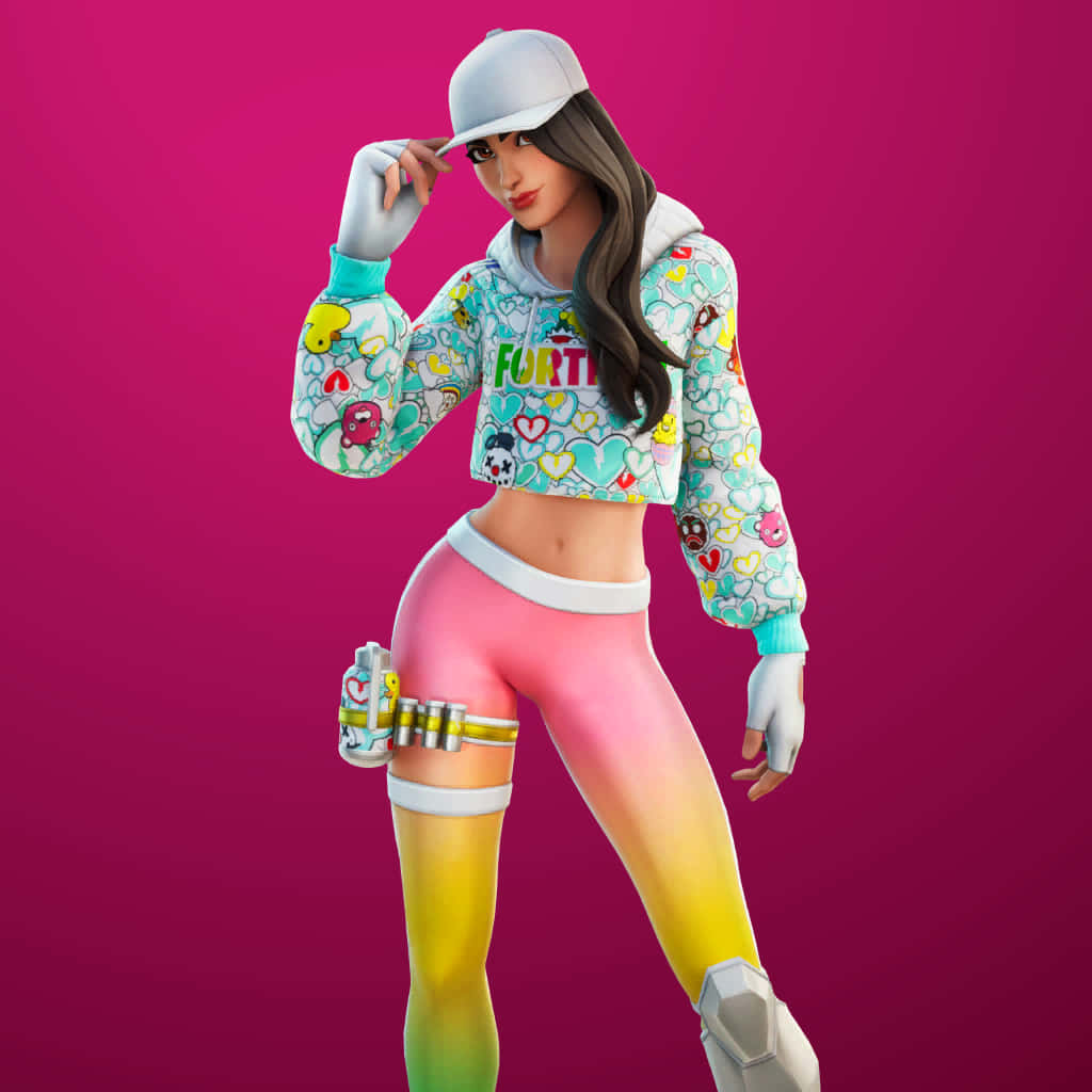 穿上Ruby Fortnite皮膚，挑戰你的對手 壁紙 — 一個穿著彩色連帽衫和漸變緊身褲的Fortnite角色在充滿活力的粉紅色背景前自信地擺姿勢。