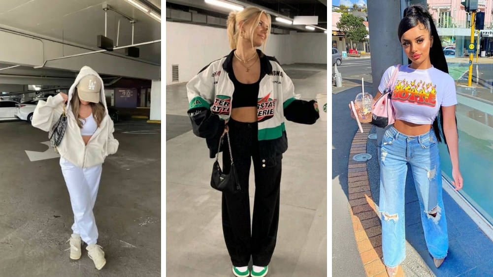 三位年輕女性穿著時尚街頭服飾在城市環境中擺姿勢。