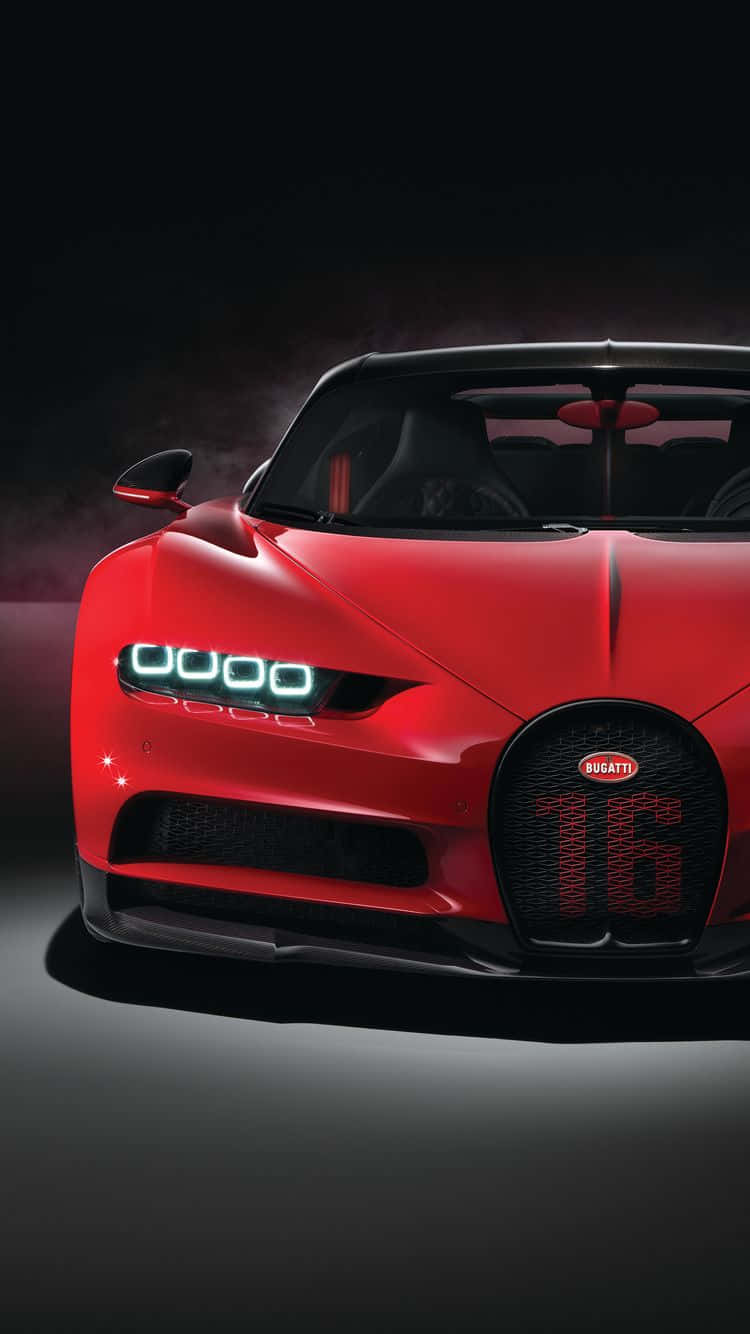 在黑暗工作室環境中，帶有發光頭燈和「16」格柵的紅色Bugatti跑車。