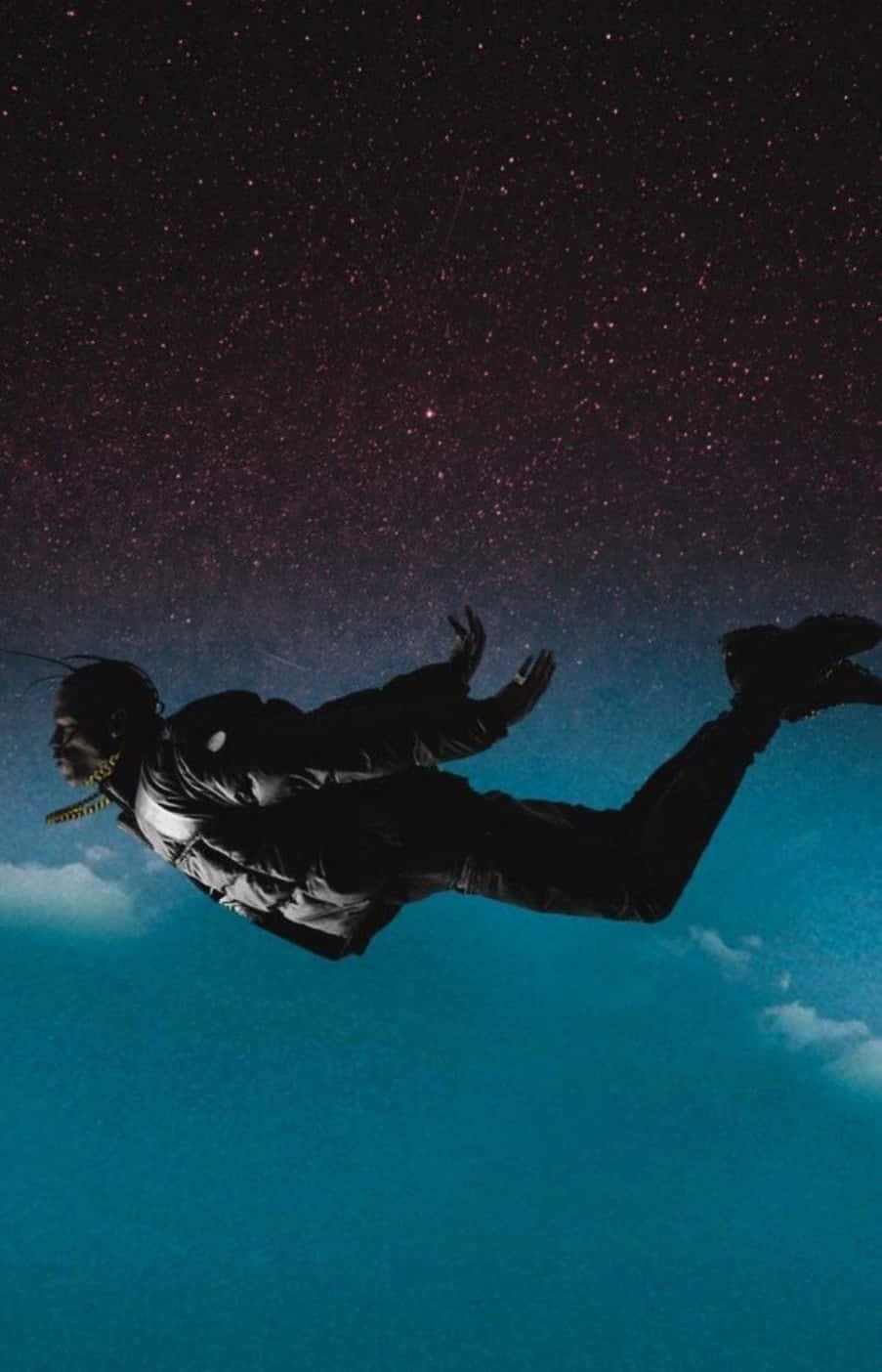 人物以剪影漂浮在繁星夜空下，伴隨青綠色雲層。