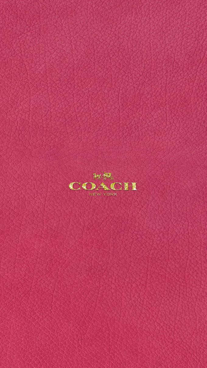 粉紅色皮革Coach手袋，金色標誌