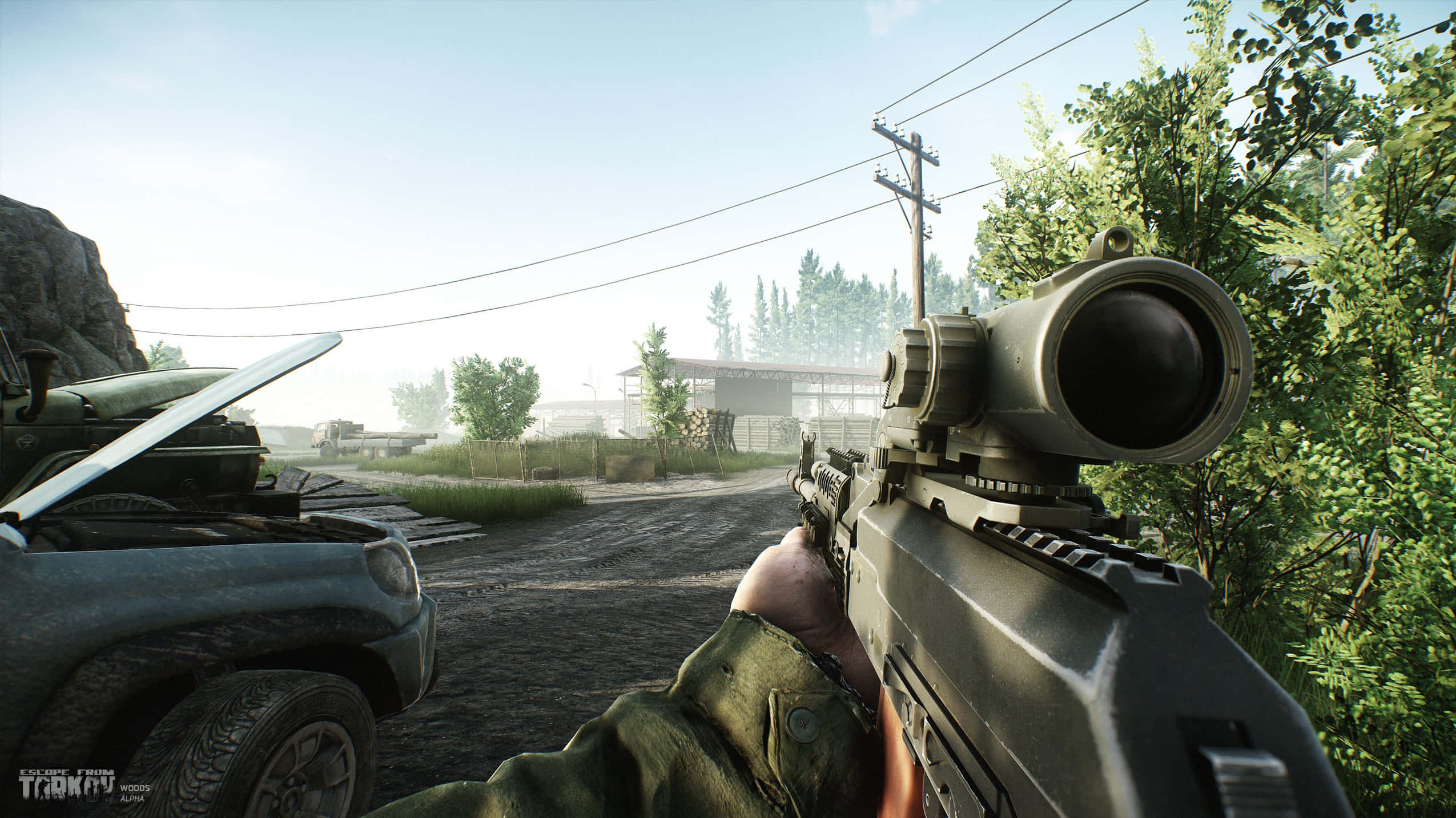 First-person Shooter Games 桌布 壁紙 — 第一人稱視角，在陽光明媚的鄉村環境中手持帶瞄準鏡的步槍，有一輛破卡車和遠處的建築物。