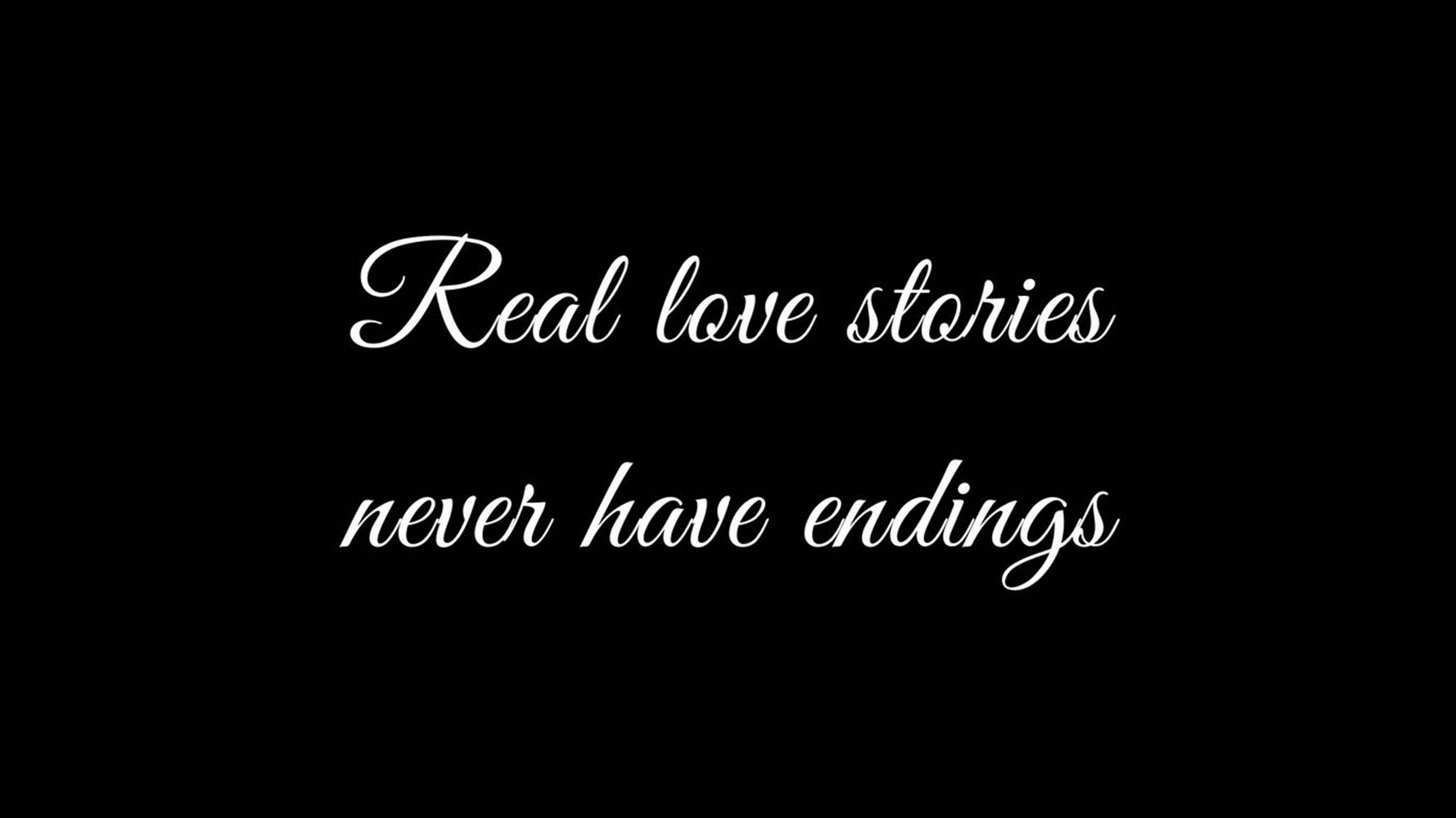 黑色背景上的白色草書文字寫著「Real love stories never have endings」