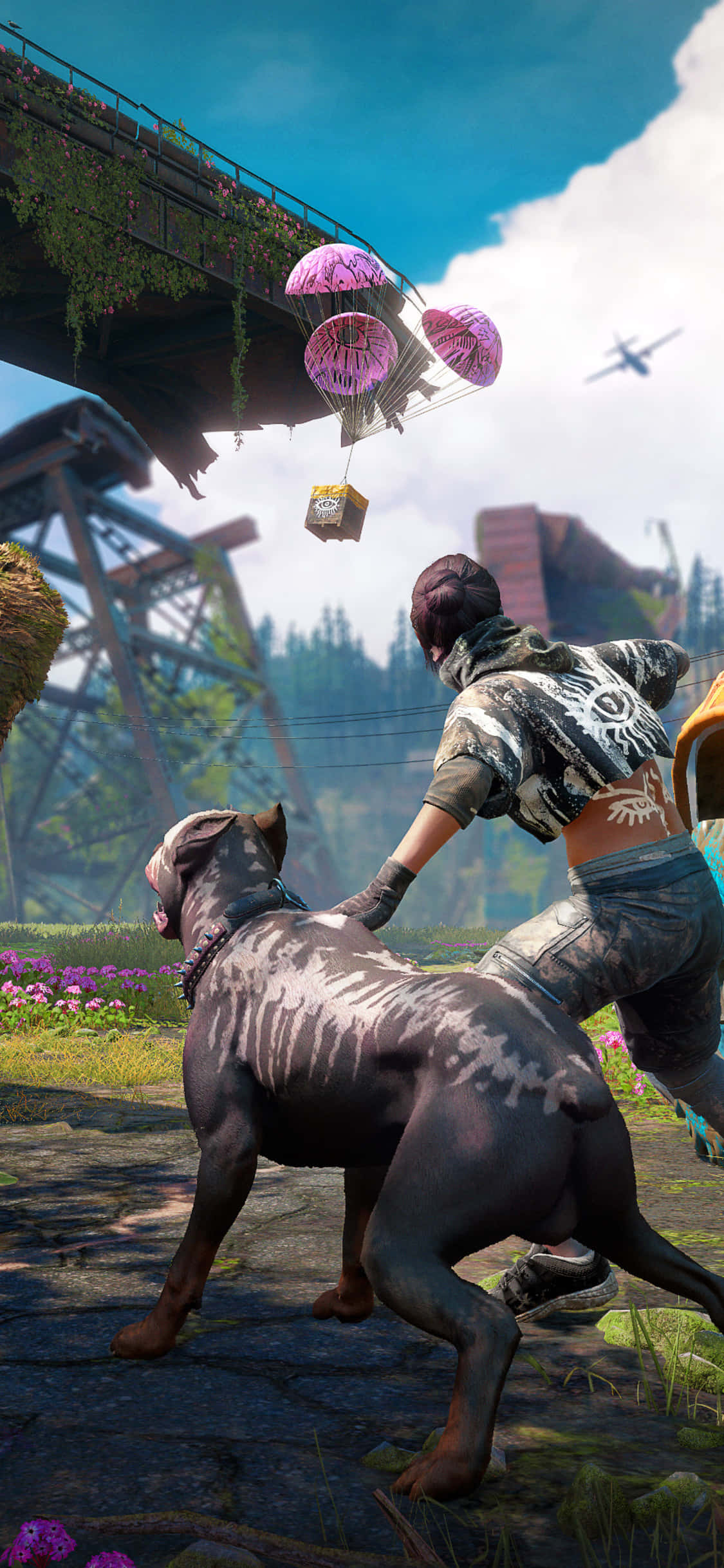 等待戰利品背景：Far Cry New Dawn Pixel 3 壁紙 — 玩家和一隻大狗在橋下的石徑上奔跑，粉紅色降落傘在充滿活力的開放世界遊戲場景中飄落。