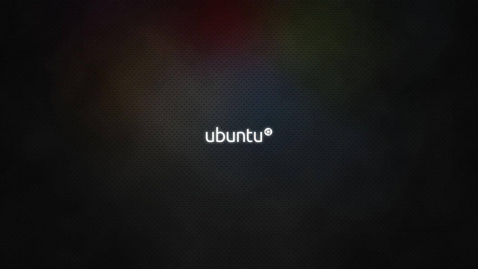 深色紋理背景上的 Ubuntu 標誌，帶有柔和彩虹模糊效果。