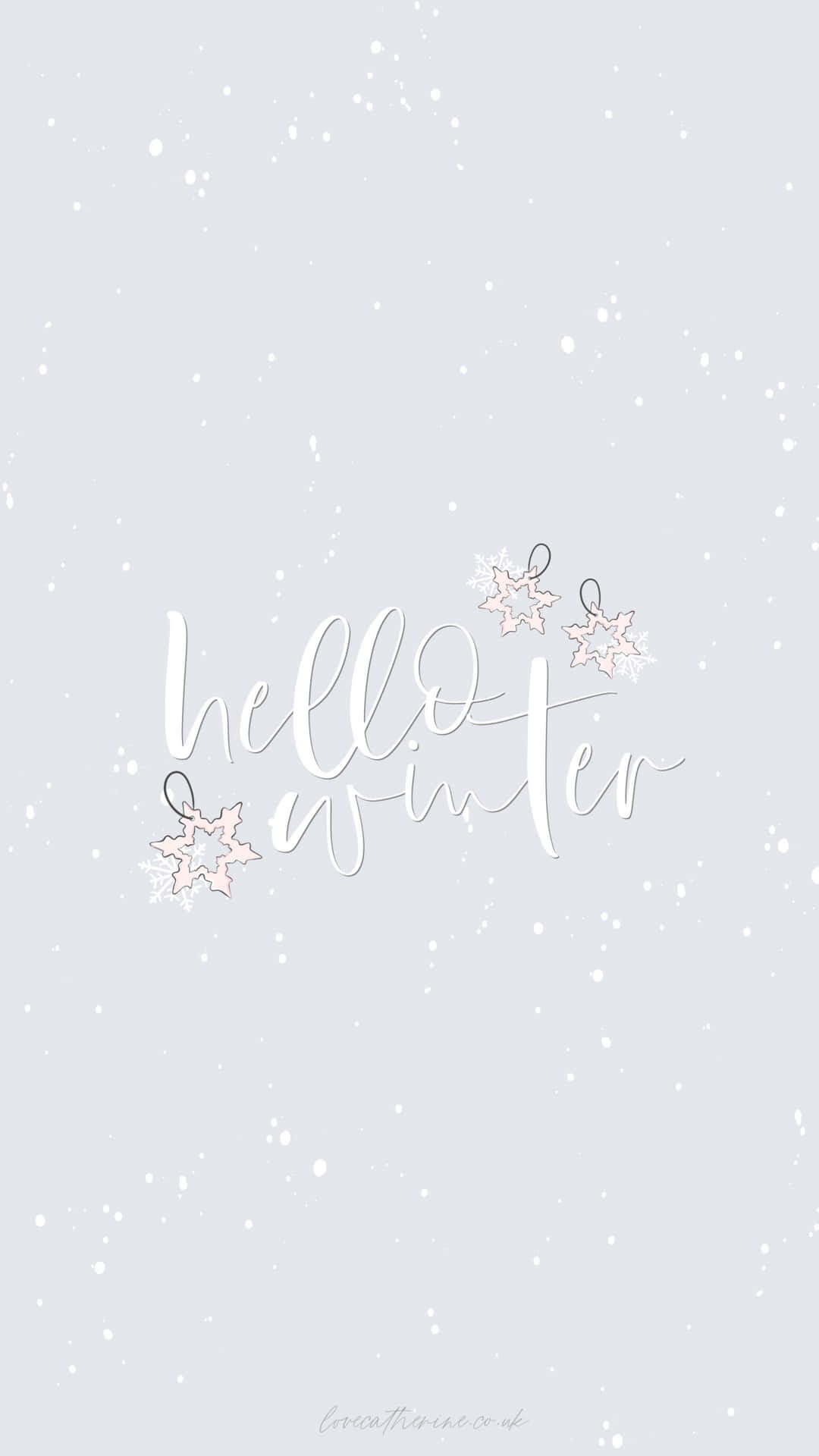灰色背景上雪花飄落的 hello winter 文字