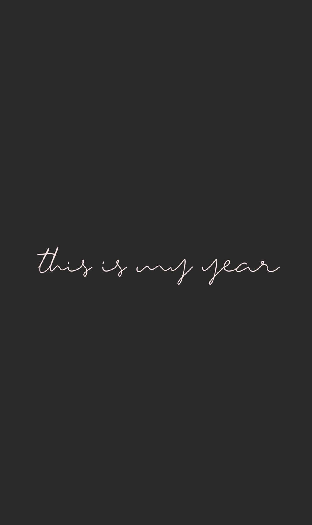 Positive 桌布 壁紙 — 簡約深灰色背景，中央優雅白色草書文字寫著 this is my year。
