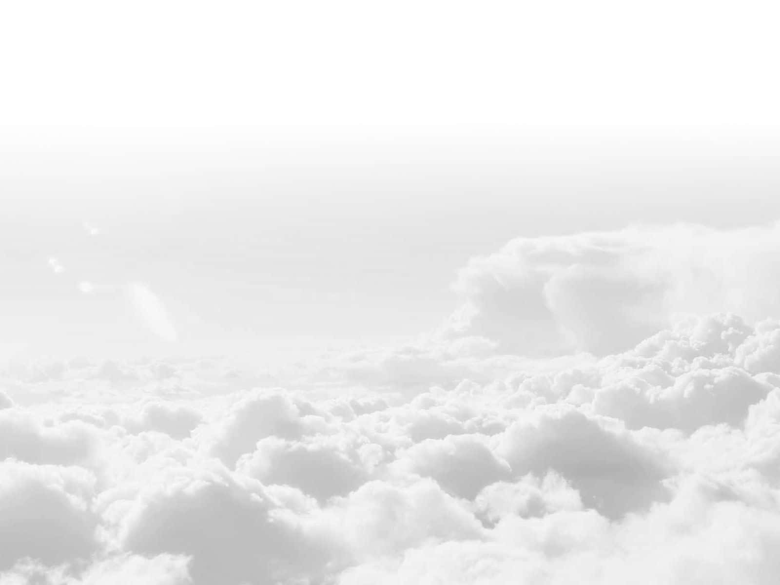 在柔和的灰色天空中漂浮的蓬鬆白雲的和平景色。