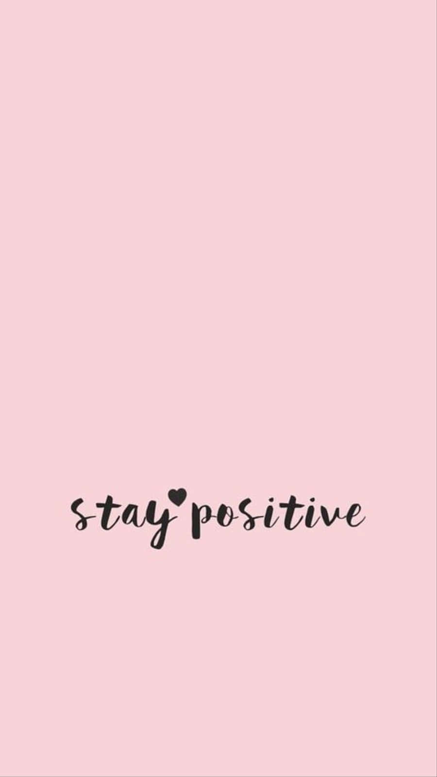 可愛少女風gif 桌布 壁紙 — 簡約粉紅色背景，黑色草書文字寫著 stay positive，並用心形取代 i 上的一點。