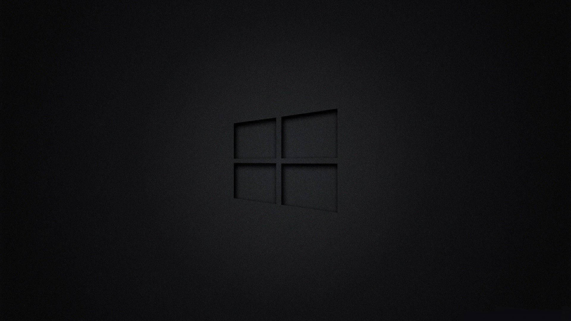 Windows標誌壓印在帶有柔和光線的紋理深色表面上。