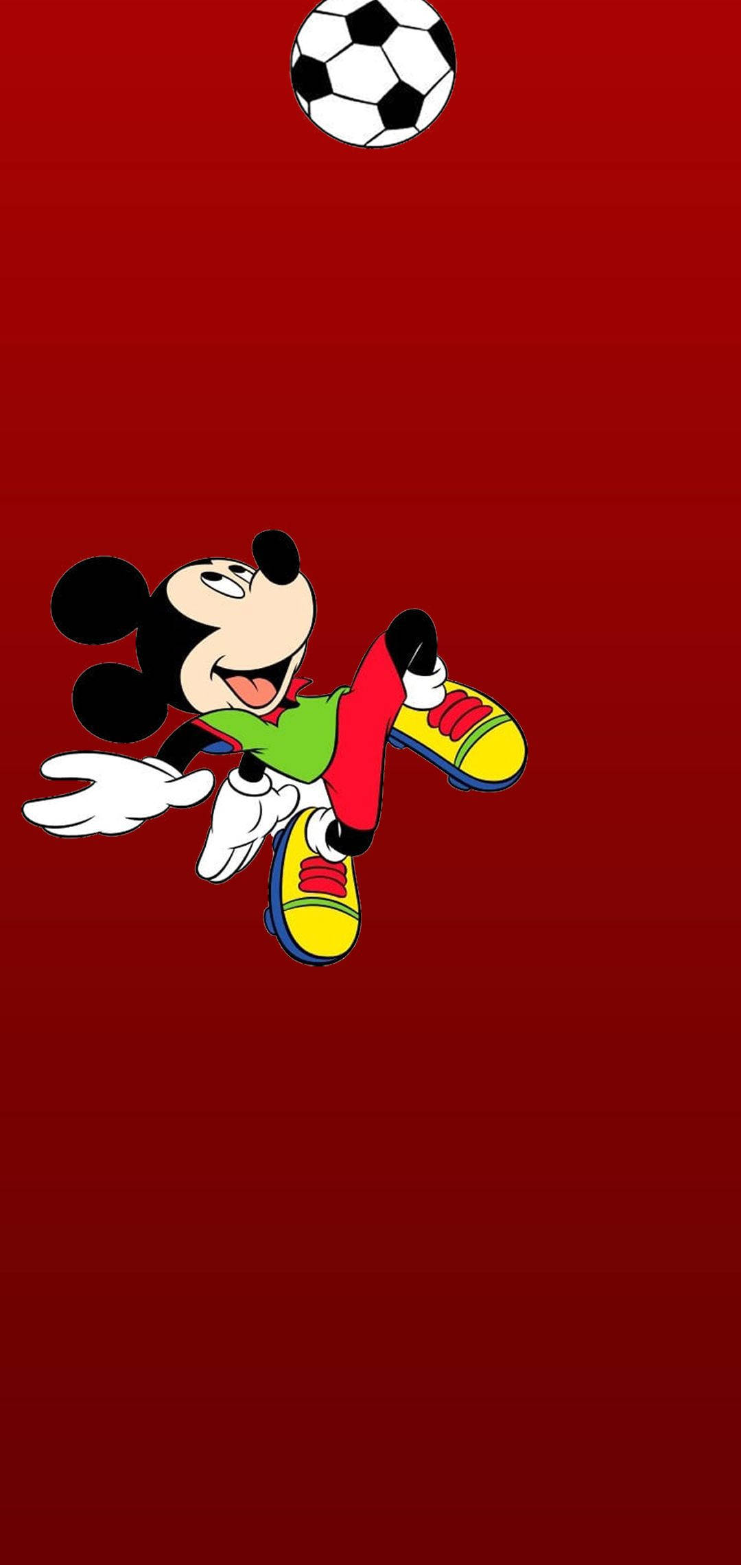 mickey mouse iPhone 桌布 壁紙 — 米奇老鼠身穿綠色球衣和黃色鞋子，在純紅色背景前踢足球。